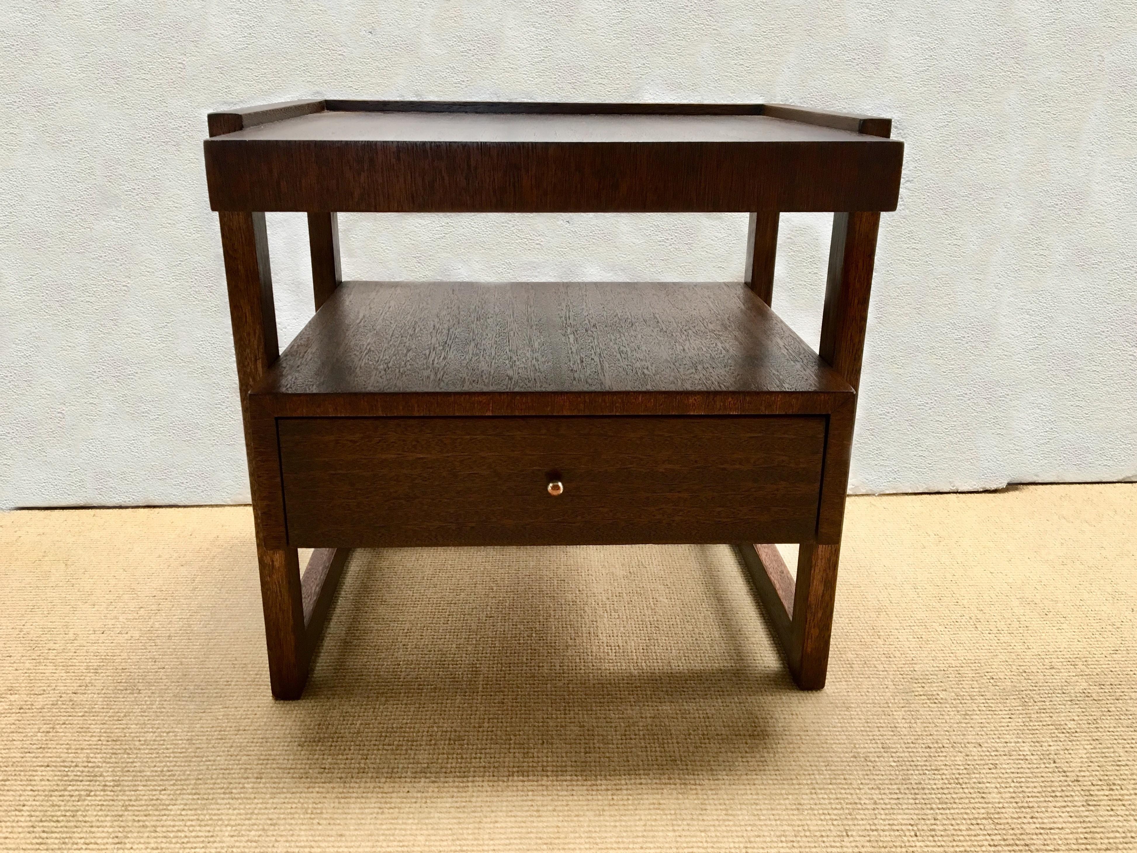 An architectural design single side table made of walnut and designed by Paul Laszlo for Brown-Saltman, California.

