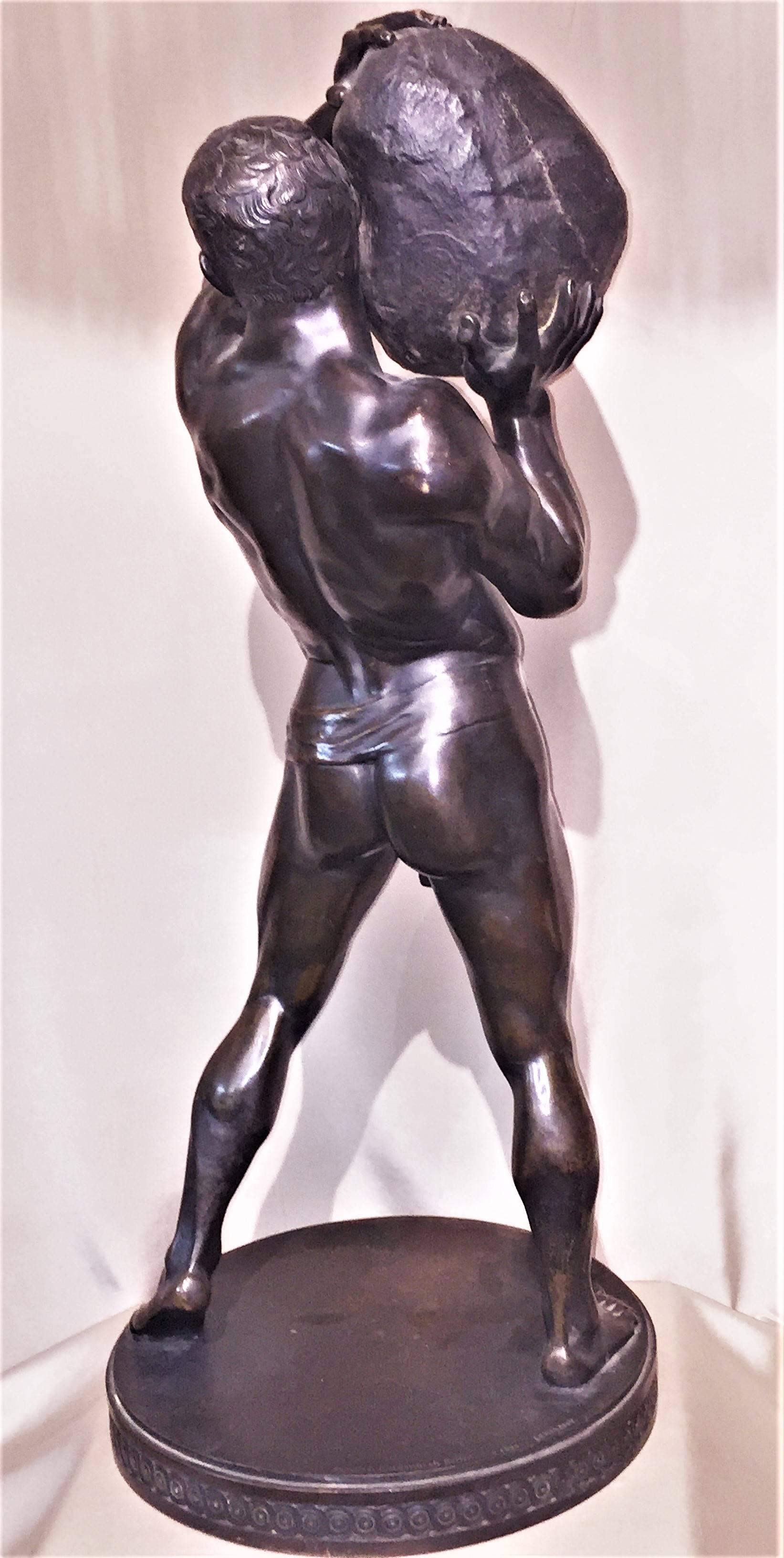 This extremely impressive depiction of Sisyphus, the figure from Greek mythology in darkly patinated bronze as an athletic male figure with energetic facial expression, wearing only a loincloth, stiffening a boulder over his right shoulder, on