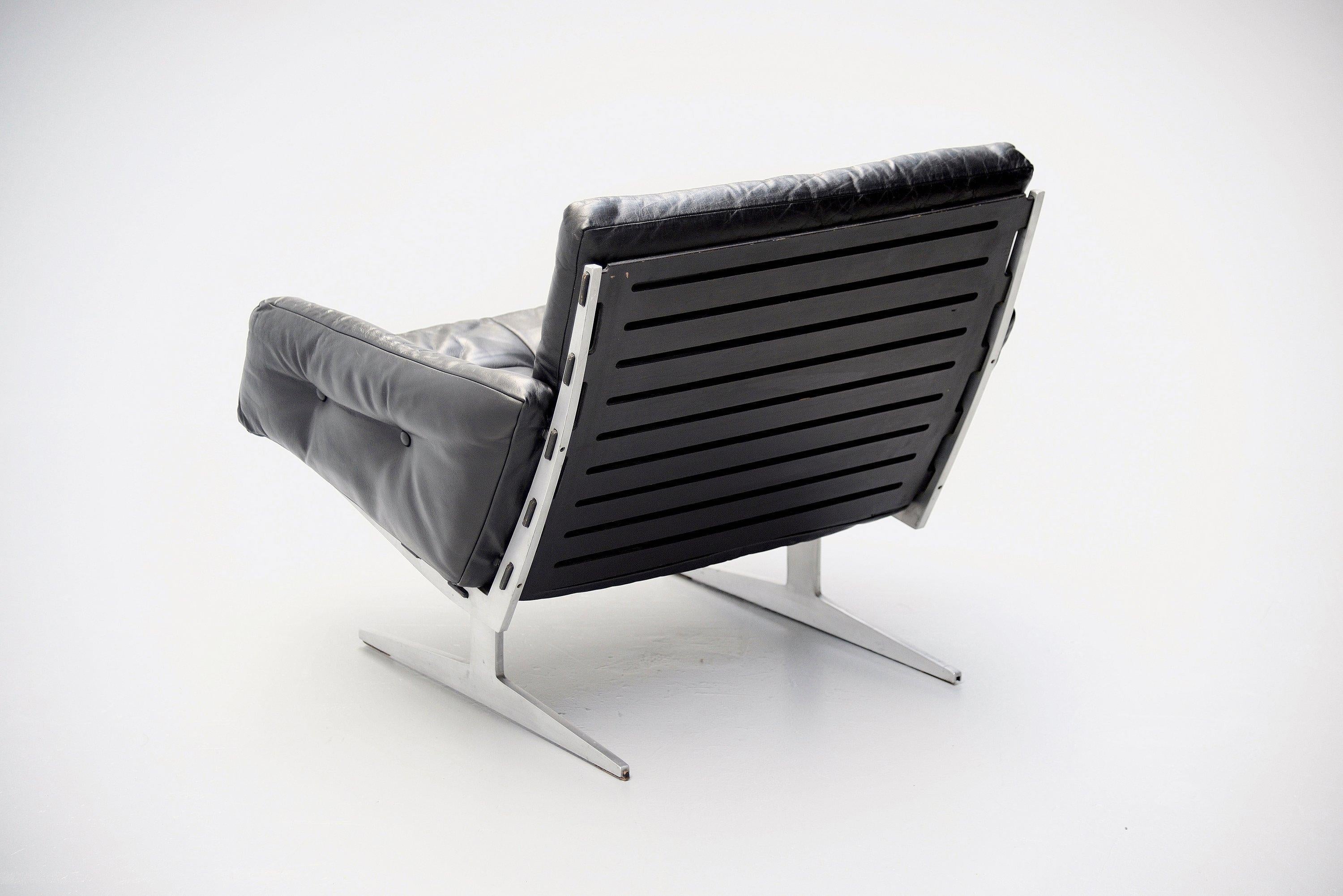 Nice armchair designed by Paul Leidersdorff and manufactured by A. Leidersdorffsen A/S, Denmark, 1965. The chair has a solid aluminum slipper frames, with black lacquered plywood seat and back and tufted leather cushions and arm rests. Very nice
