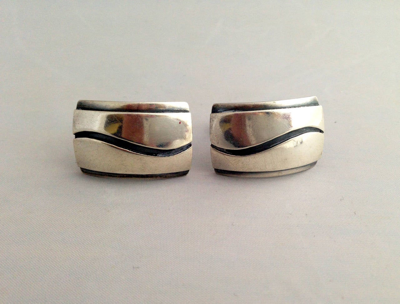 Large scale sterling silver cufflinks with applied wave design created by Paul Lobel of New York, circa 1950's.  Cufflinks measure 1 1/8