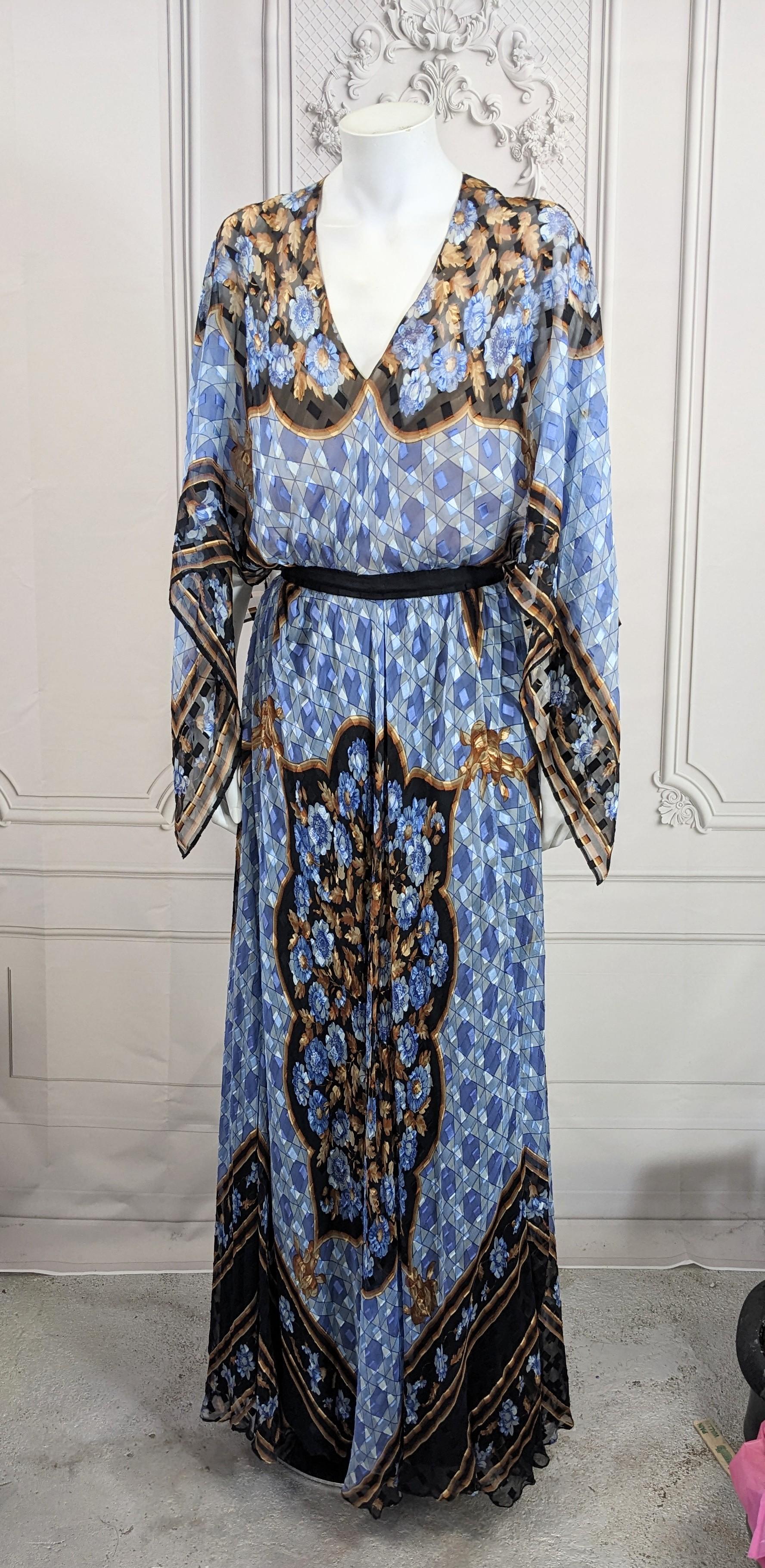 Elegant Paul Louis Orrier Placed Print Chiffon Scarf Point Gown from the 1970's, France. One piece silk chiffon gown with floral print on a Moorish ground, has a super full skirt attached to a nude liner bodice. A large scarf is attached at the