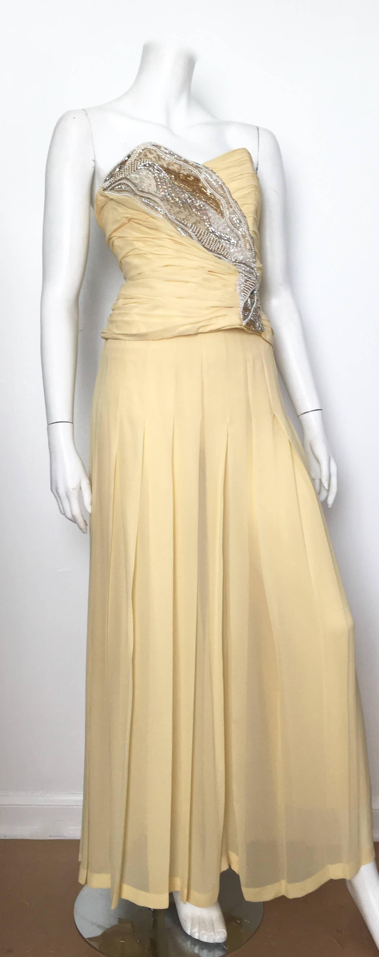 Paul Louis Orrier 1980s yellow silk beaded ruched bustier with maxi pleated skirt and long scarf is labeled a size 6 / 8 and fits a size 4.  Ladies please go and grab your tape measure so you can measure your bust line, waist & hips to make certain