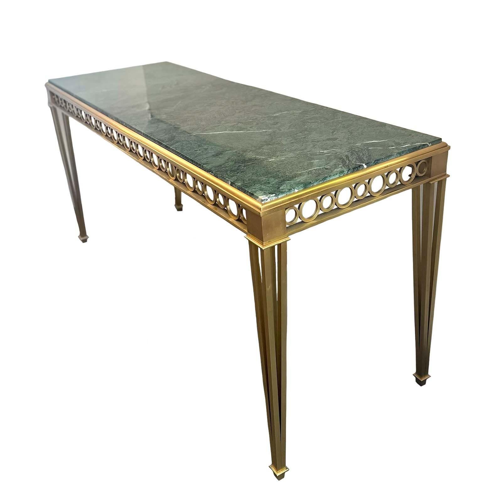 Bronze and marble Neoclassical-style console table by Paul M. Jones surrounded by circle pattern apron details and tapered legs in quality bronze. The piece stands out due to the beautiful green marble top. Made in USA, c. 1960's.
Dimensions:
31