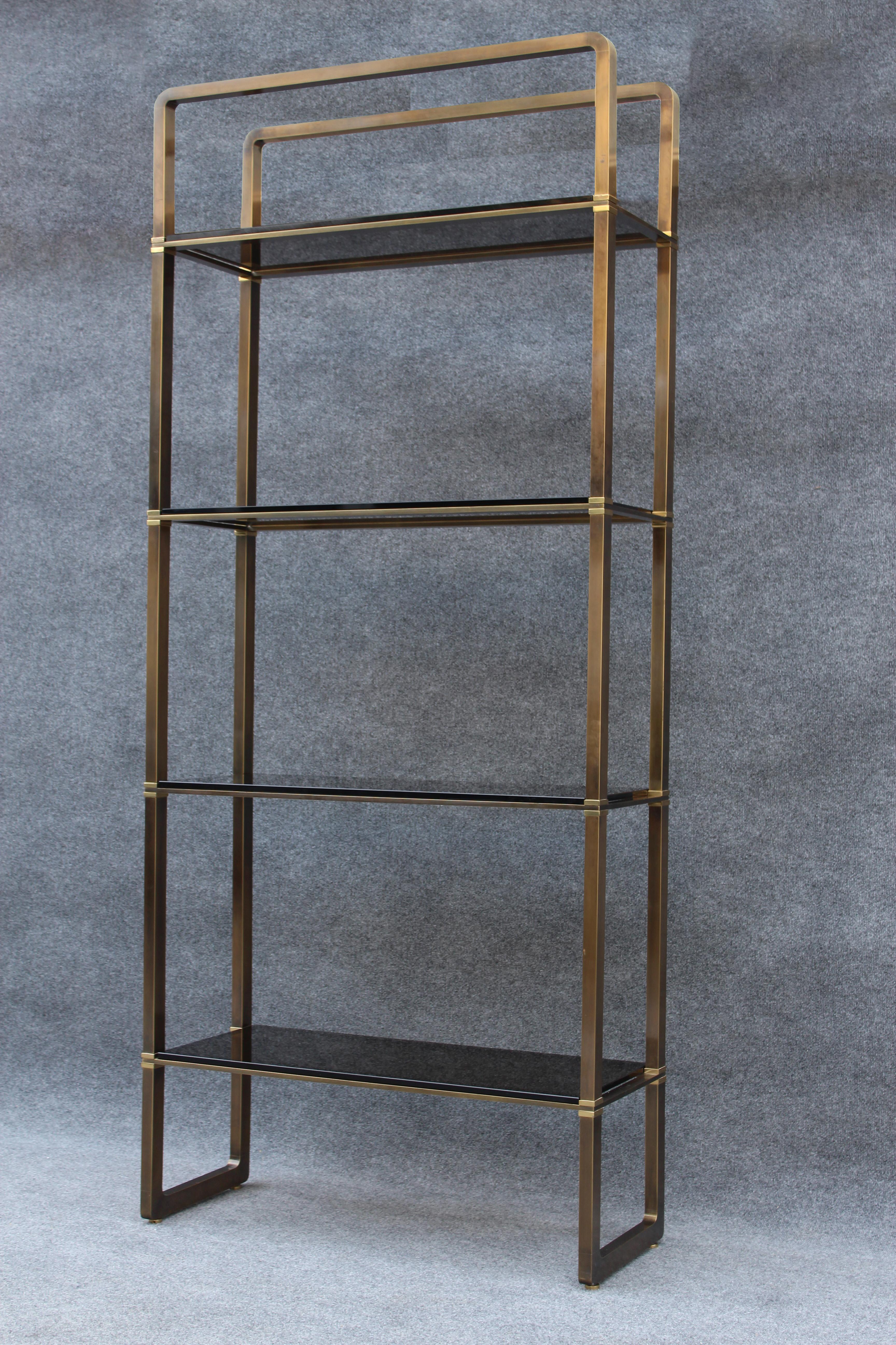 By American designer Paul M. Jones, this etagere features an excellent design and superb construction. Made of a frame of solid brass, each corner is meticulously rounded and the entire frame brushed to perfection. Each of the 4 panes of thick