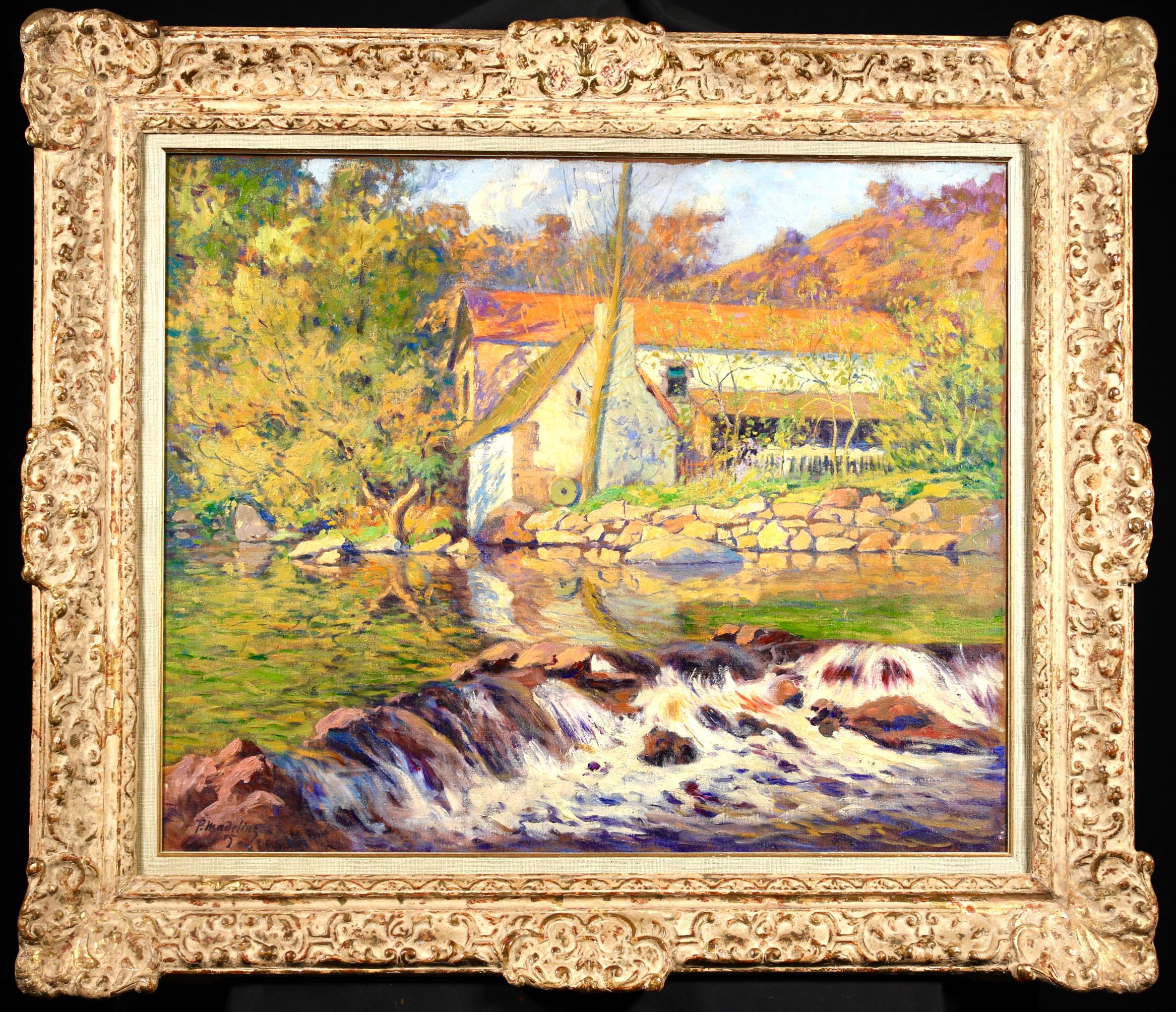 Huile sur toile originale signée et datée du peintre post impressionniste français Paul Madeline. Cette belle œuvre représente un moulin au bord d'une rivière - l'eau cascadant sur les rochers au premier plan et les arbres d'automne au loin, avec un