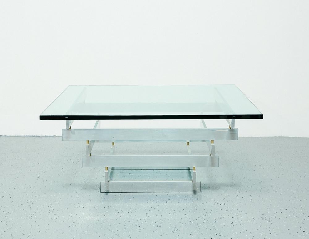 Sculptural coffee table designed by Paul Mayen for Habitat.

Aluminum frame and 3/4 inch thick glass top.