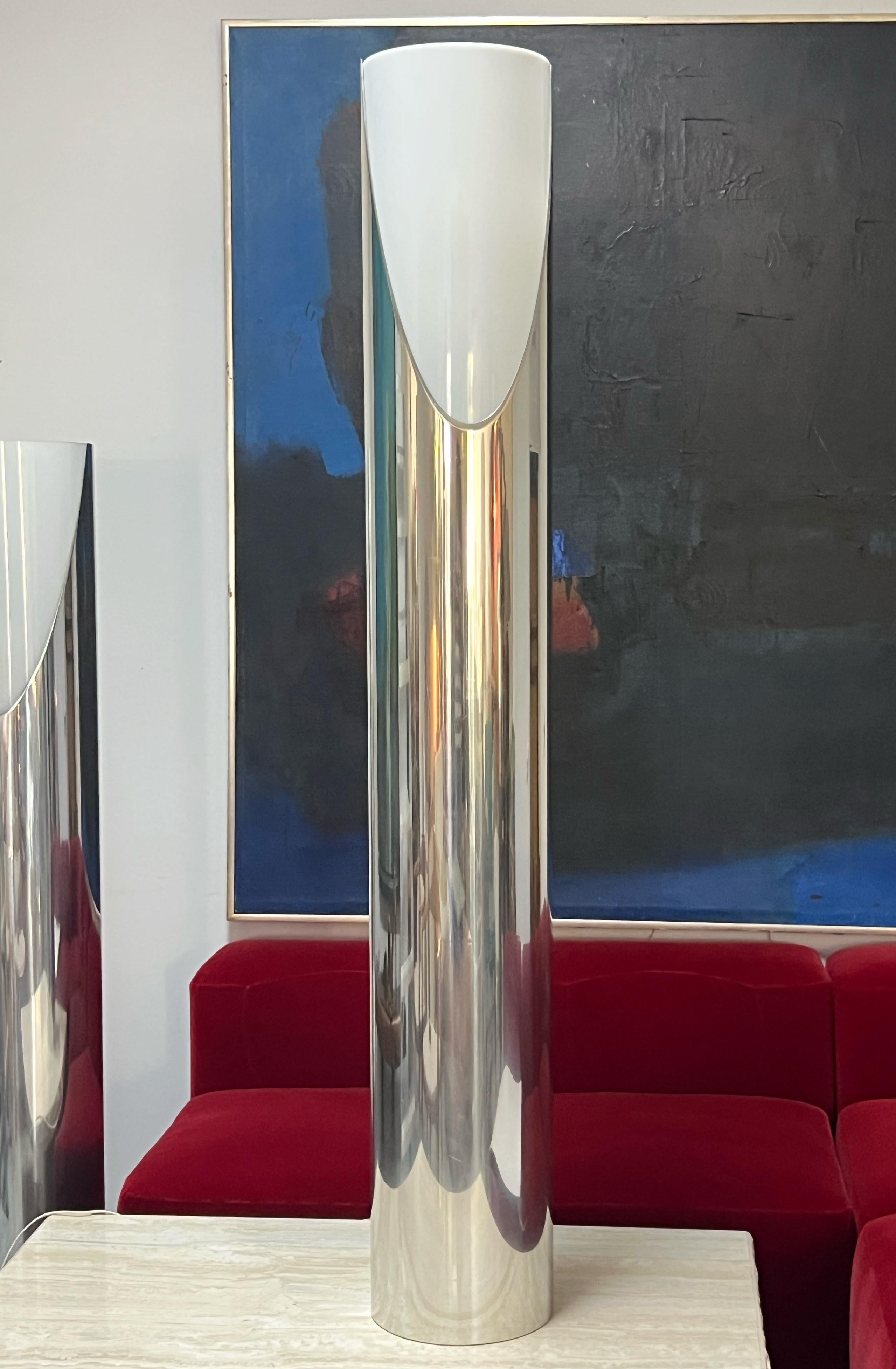 A monolithic cylinder floor lamps by Paul Mayen for Habitat International. The body is polished aluminum with an acrylic diffuser. Takes 3 regular bulbs and 1 spot facing upward that can be used by itself or in unison with the others. 