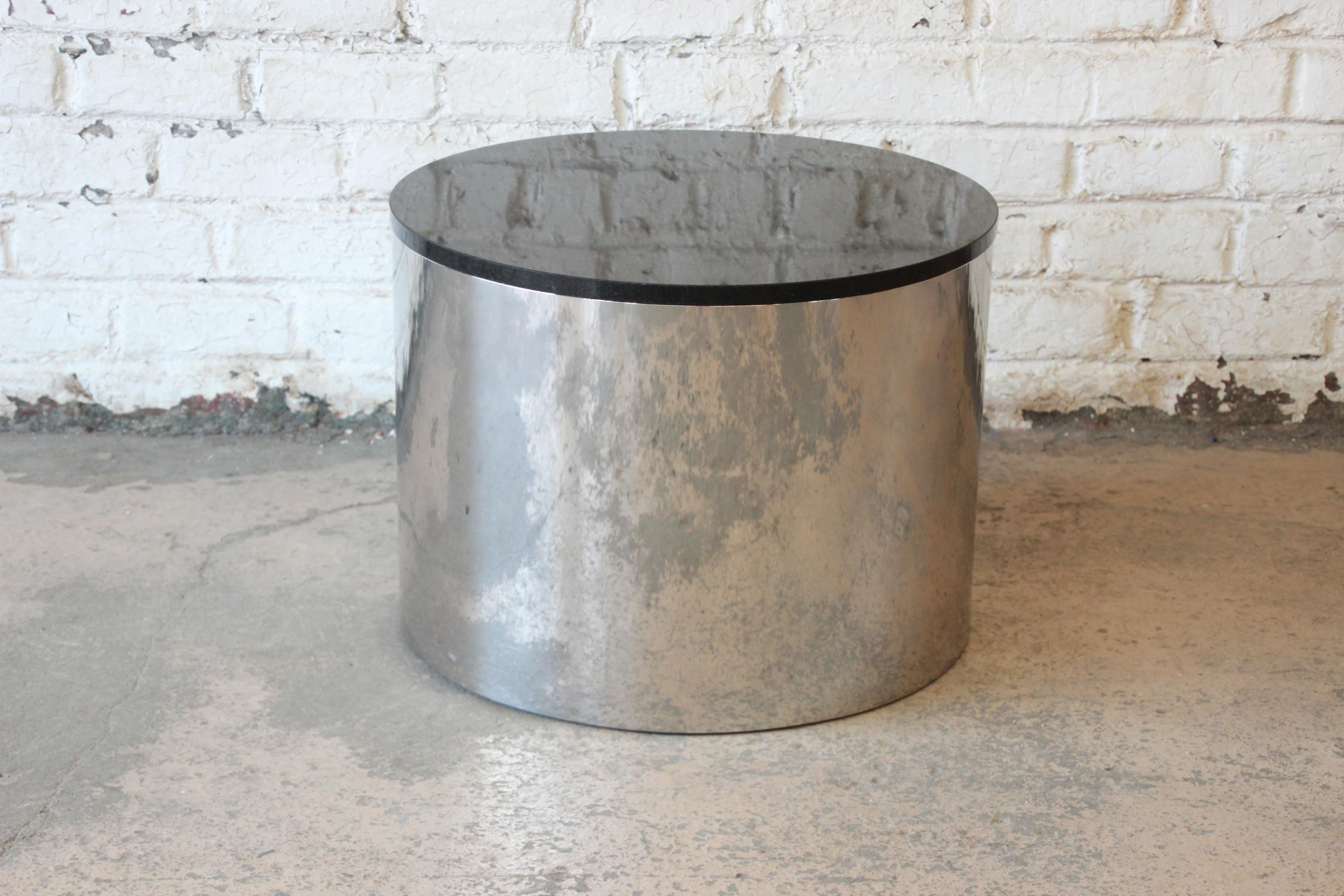 A very nice Mid-Century Modern polished aluminum and black granite top drum cocktail table designed by Paul Mayen for Habitat. The table is in very good original condition, with minimal wear from age and use. A perfect addition to any modern