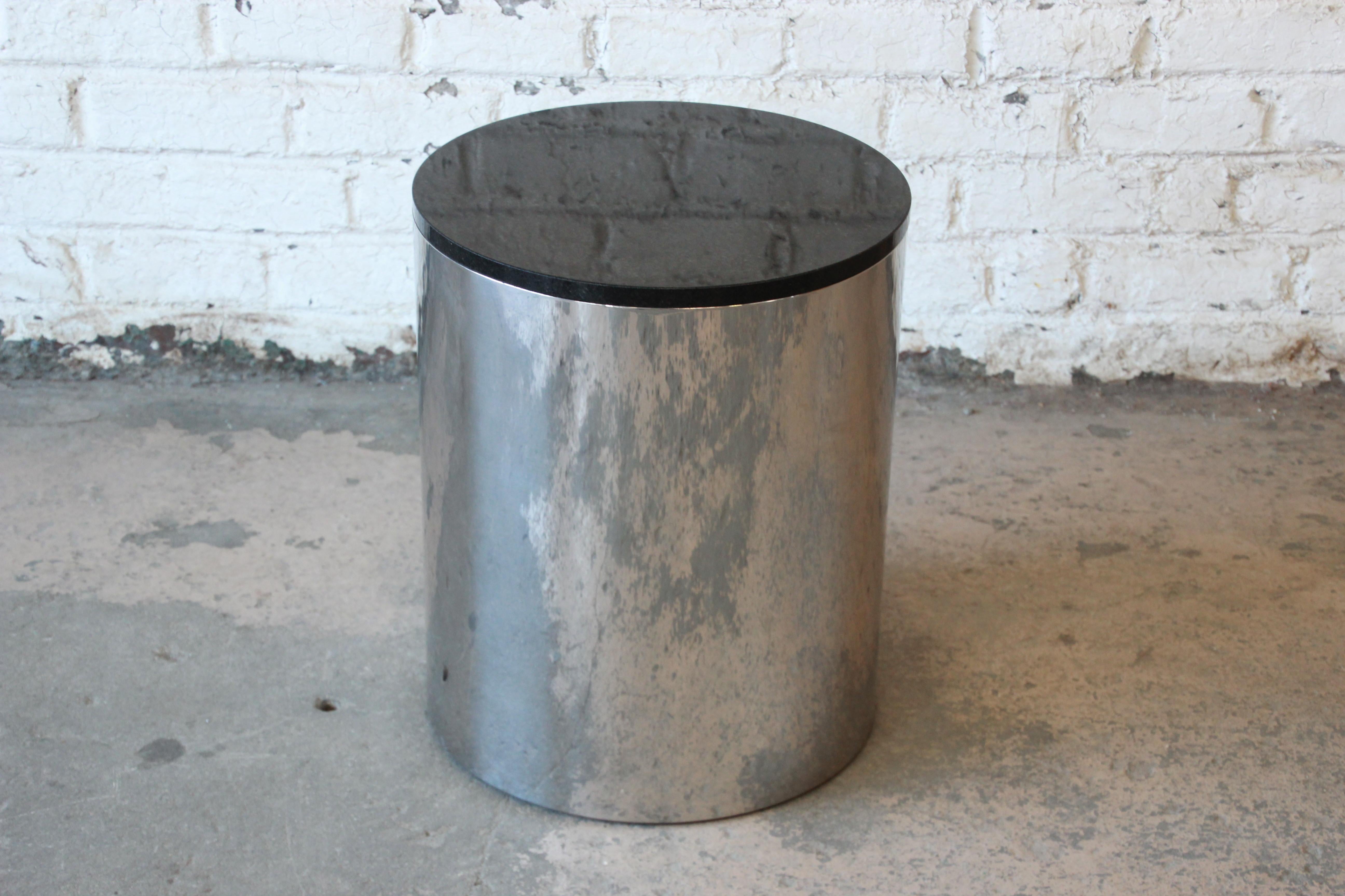 A nice Mid-Century Modern polished aluminum and black granite top drum side table or plant stand by Paul Mayen for Habitat. The table is in very good original condition, with minimal wear from age and use. A perfect addition to any modern