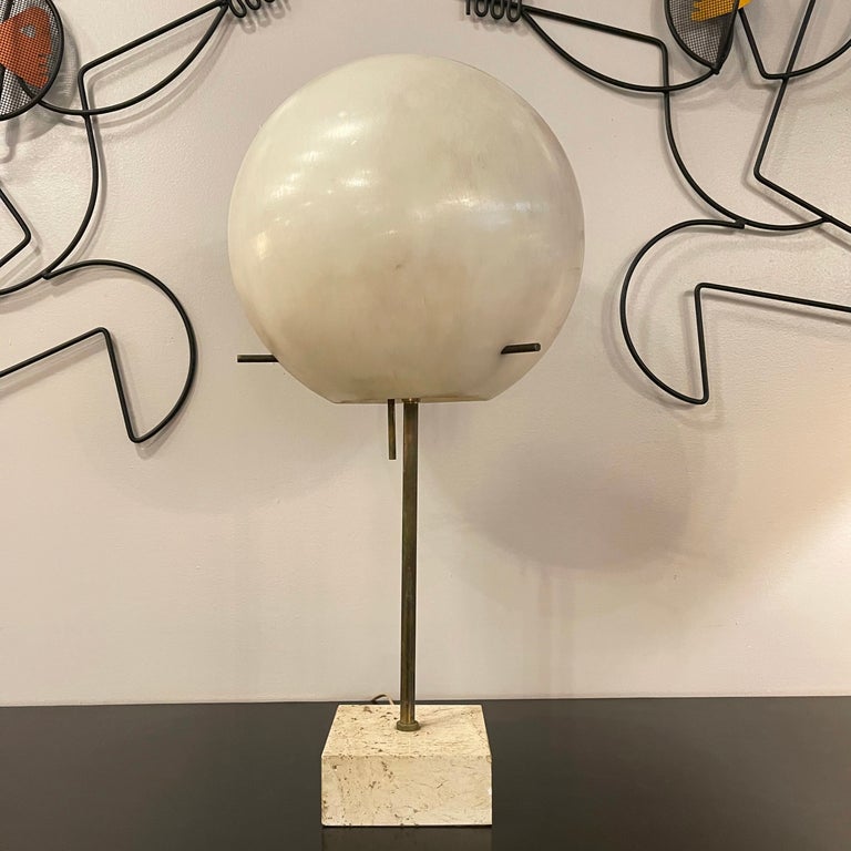 Midcentury, modernist, lollipop table lamp by Paul Mayen for Habitat features a thick polypropylene globe shade with patinated brass pole on a 5.25 inch square travertine base.