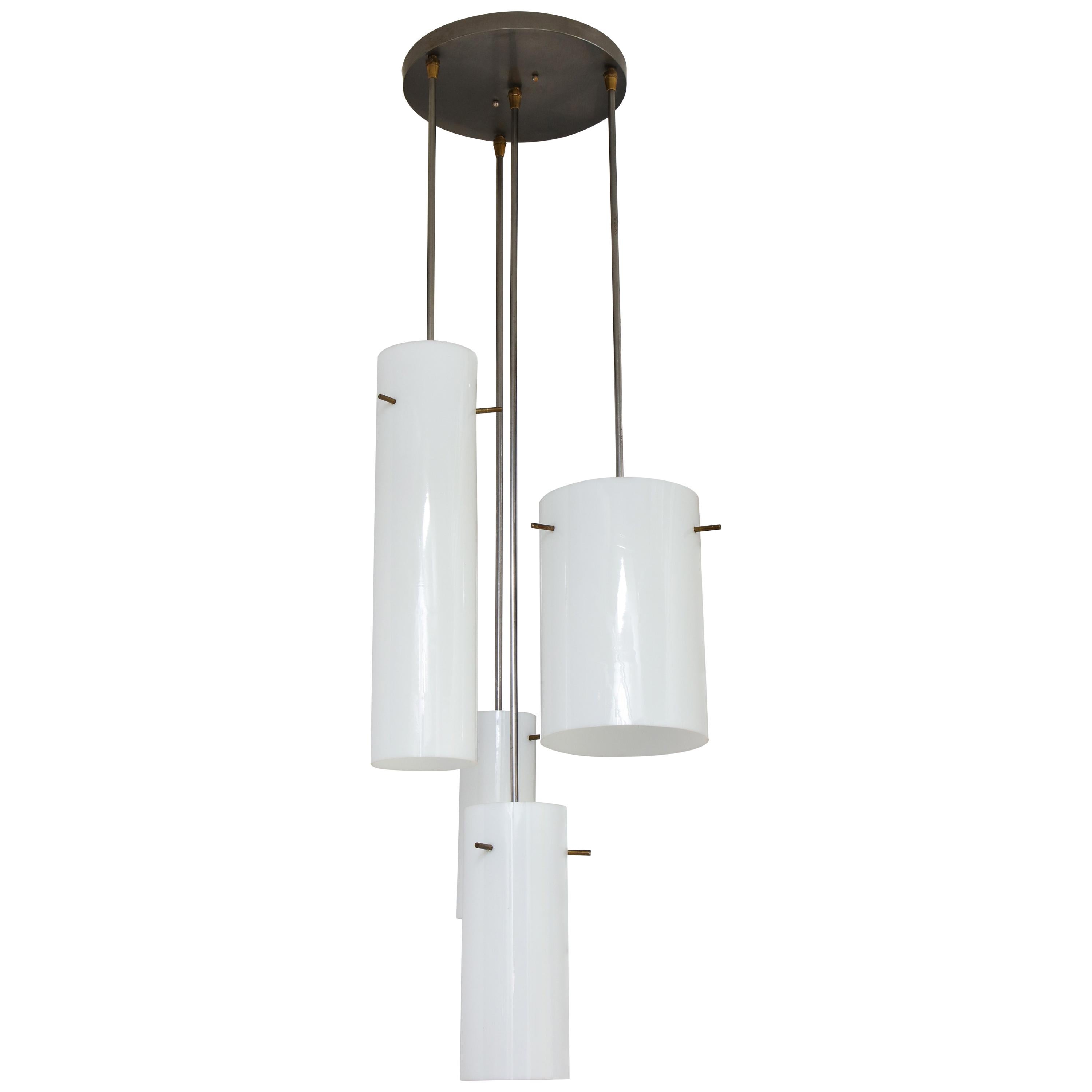 Rare hanging fixture composed of four glass cylinders of varying heights and diameters, arranged in a spiral pattern; each held by three protruding brass-plated rods. Designed by Paul Mayen and produced by Habitat, circa 1958. An artful composition,