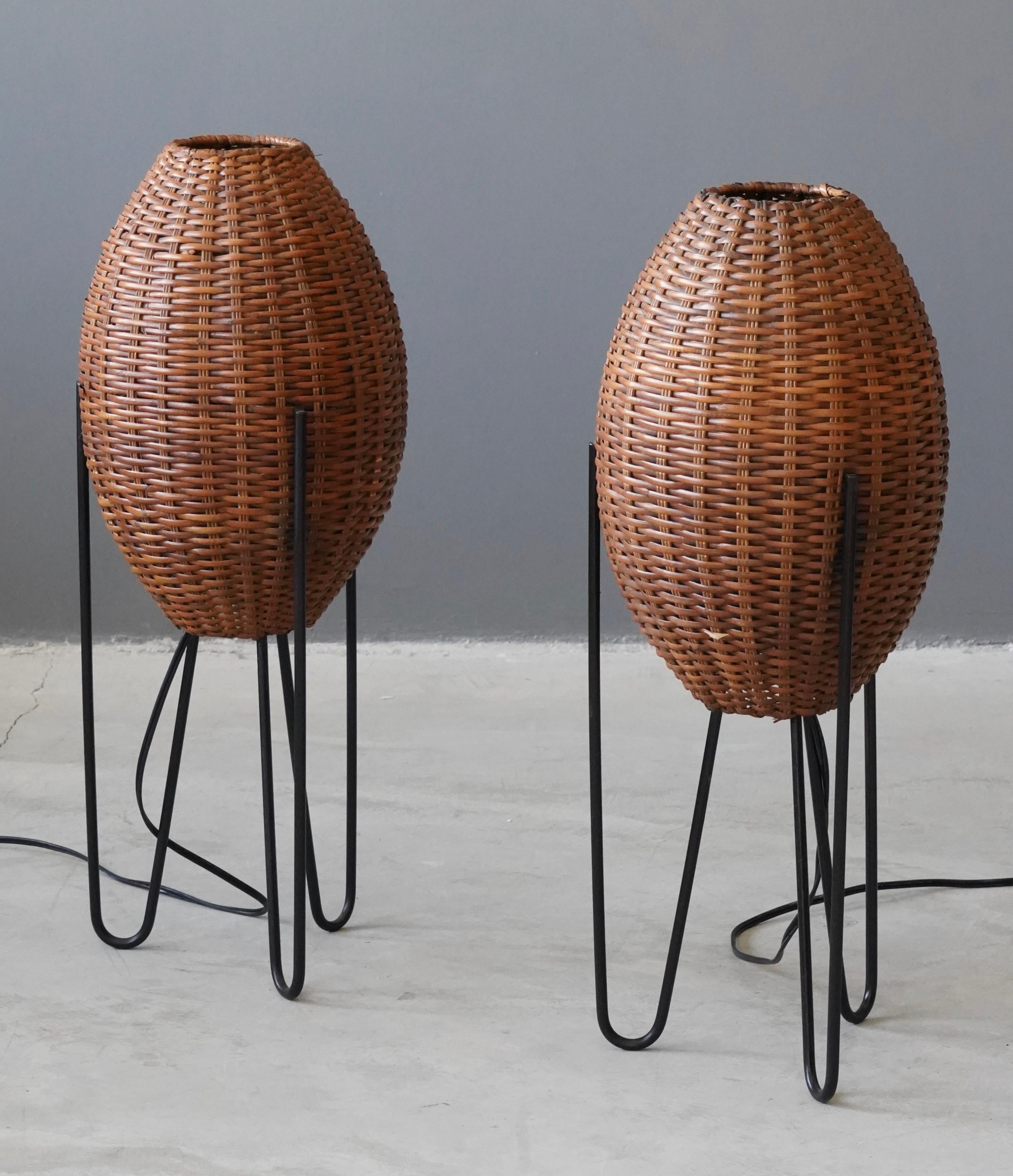 A pair of large and impressive table lamps. Designed and produced by Paul Mayén, USA, c. 1965.

Woven wicker lampshades rests on bases of black enameled metal. 

Other designers of the period include Isamu Noguchi, George Kovacs, Isamu Noguchi,