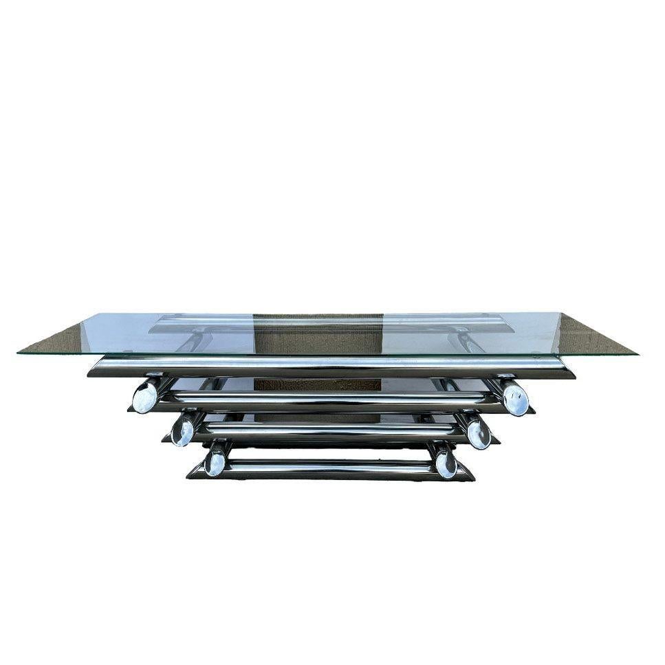 1970s Space Age chrome tubular steel coffee table with 8 layers of chromed metal tubes and a thick slightly smoked glass on top.
In the style of Paul Mayen.

Height: 16 in, Width: 43 in, Depth: 23 in

United States, 1970