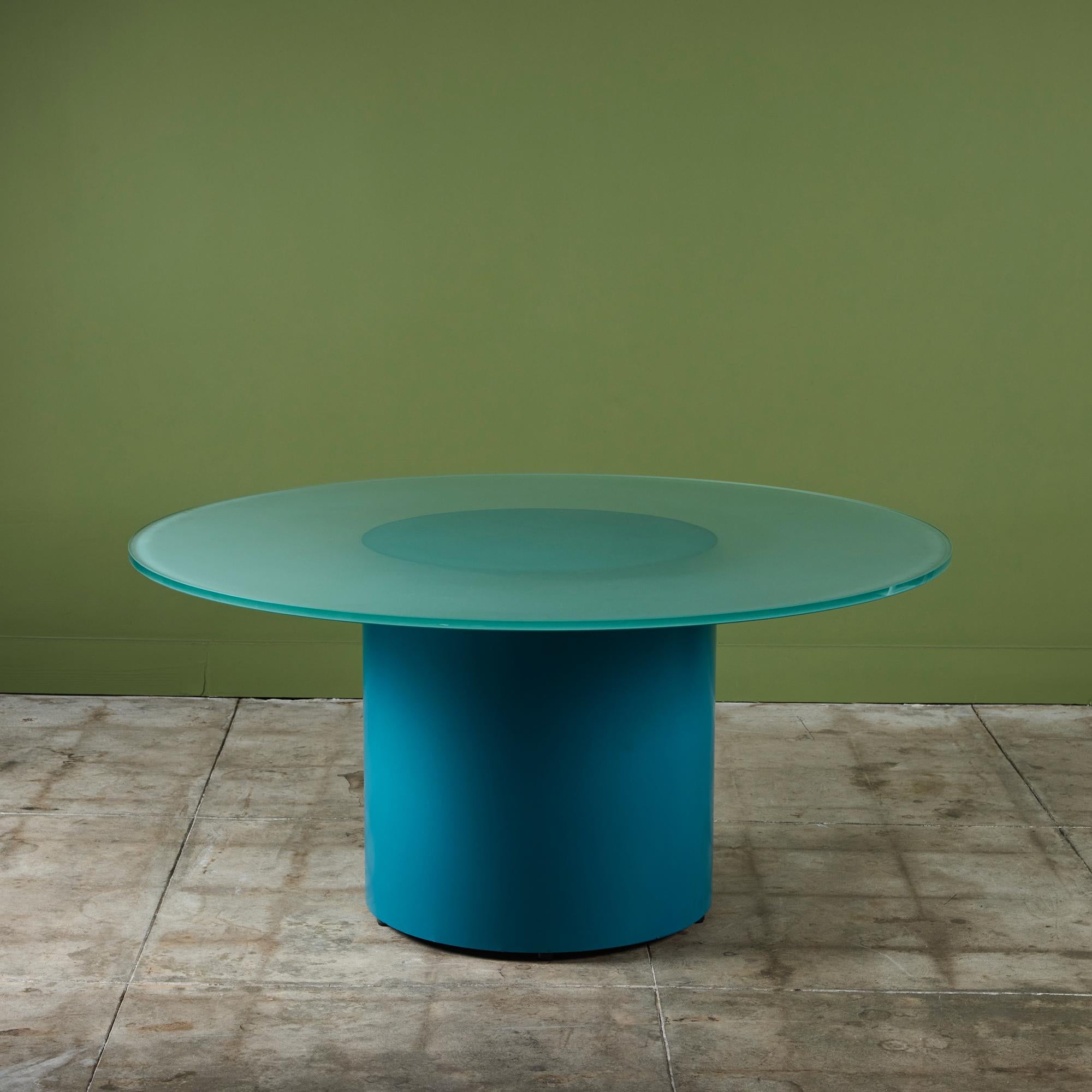 Paul Mayen postmodern style dining table features a round frosted glass table top and an aqua colored cylindrical steel pedestal base.

Dimensions
60