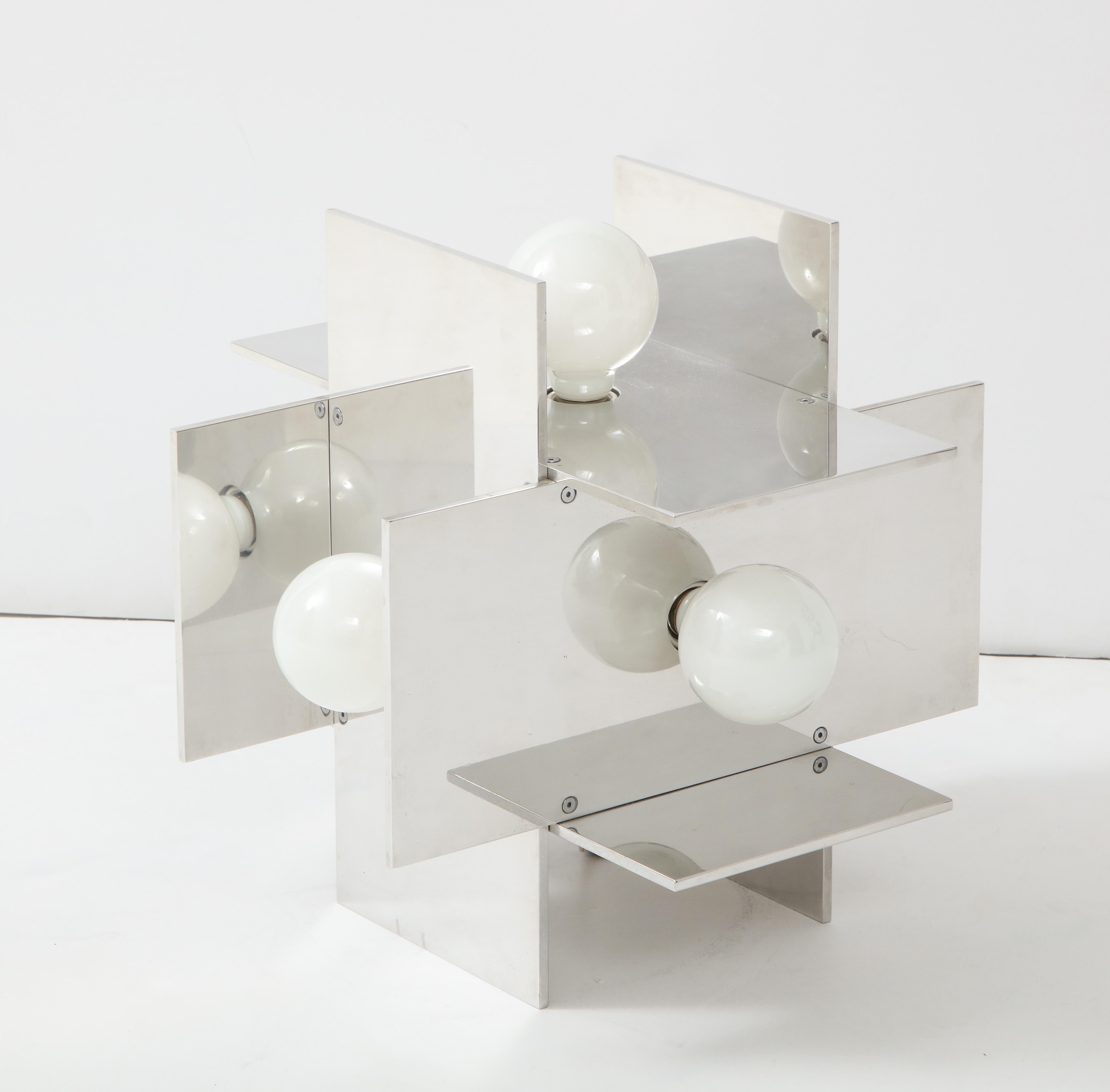 Constructivist table lamp in polished, reflective aluminum designed by Paul Mayen for Habitat, circa 1968. Catalog #9098. The Spanish-born and Cooper-Union and Columbia University educated Mayen founded Habitat in the early 1950’s; Habitat would