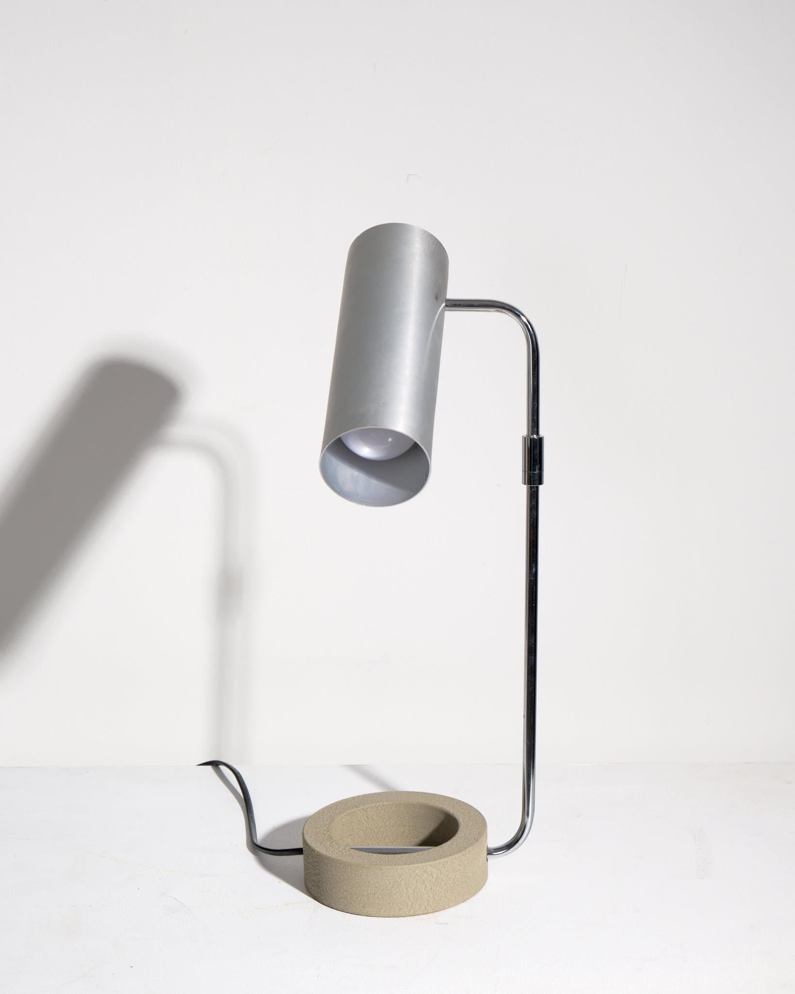 A striking Tangola table lamp designed by Paul Mayén for Habitat, produced circa 1970s–80s. This mid-century piece features a minimalist cast iron base paired with a crisp, angular aluminium shade, embodying Mayén’s signature blend of industrial