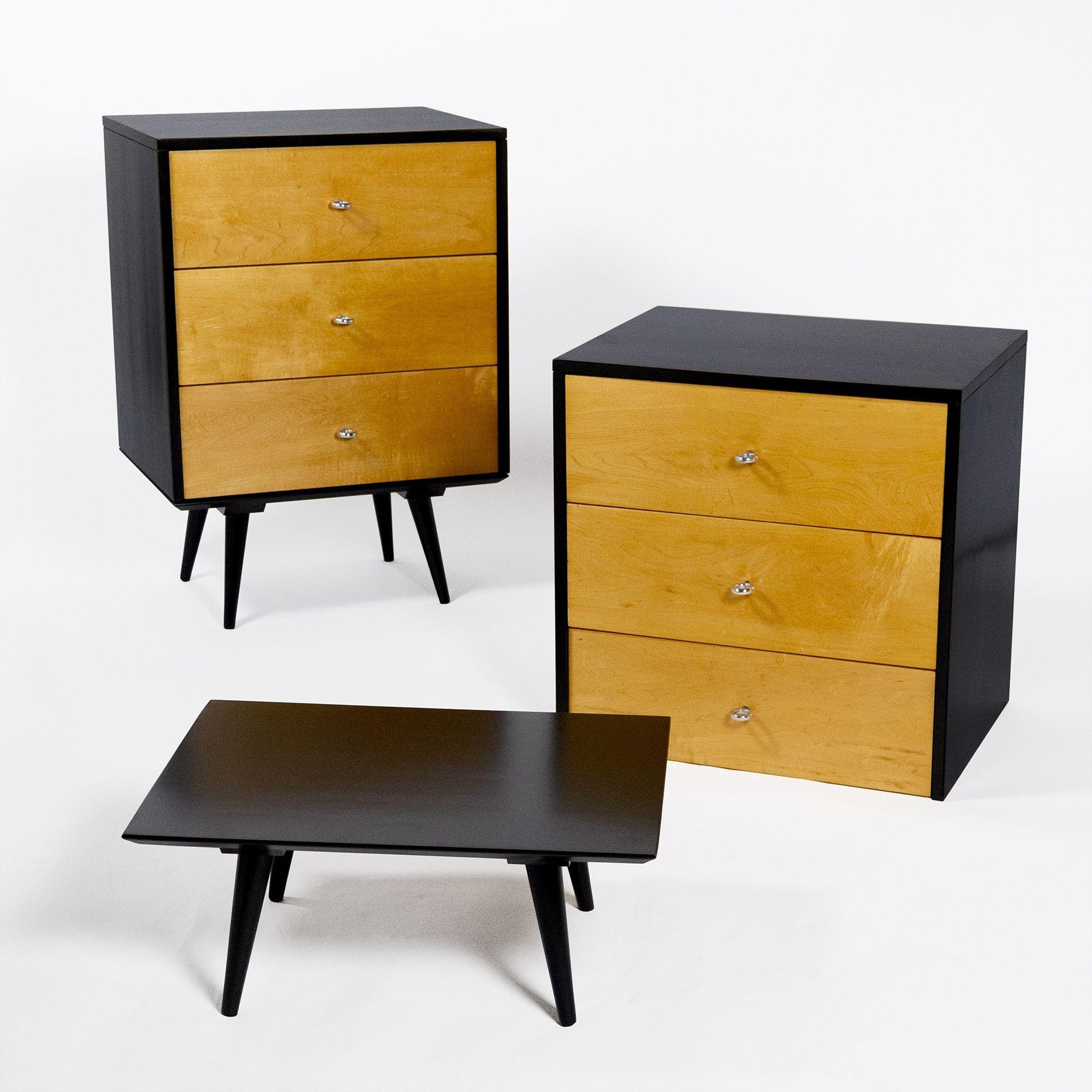 Pair of three drawer solid maple cabinets with original aluminum ring pulls that rest on separate square tables. Refinished as original in black and clear lacquer.