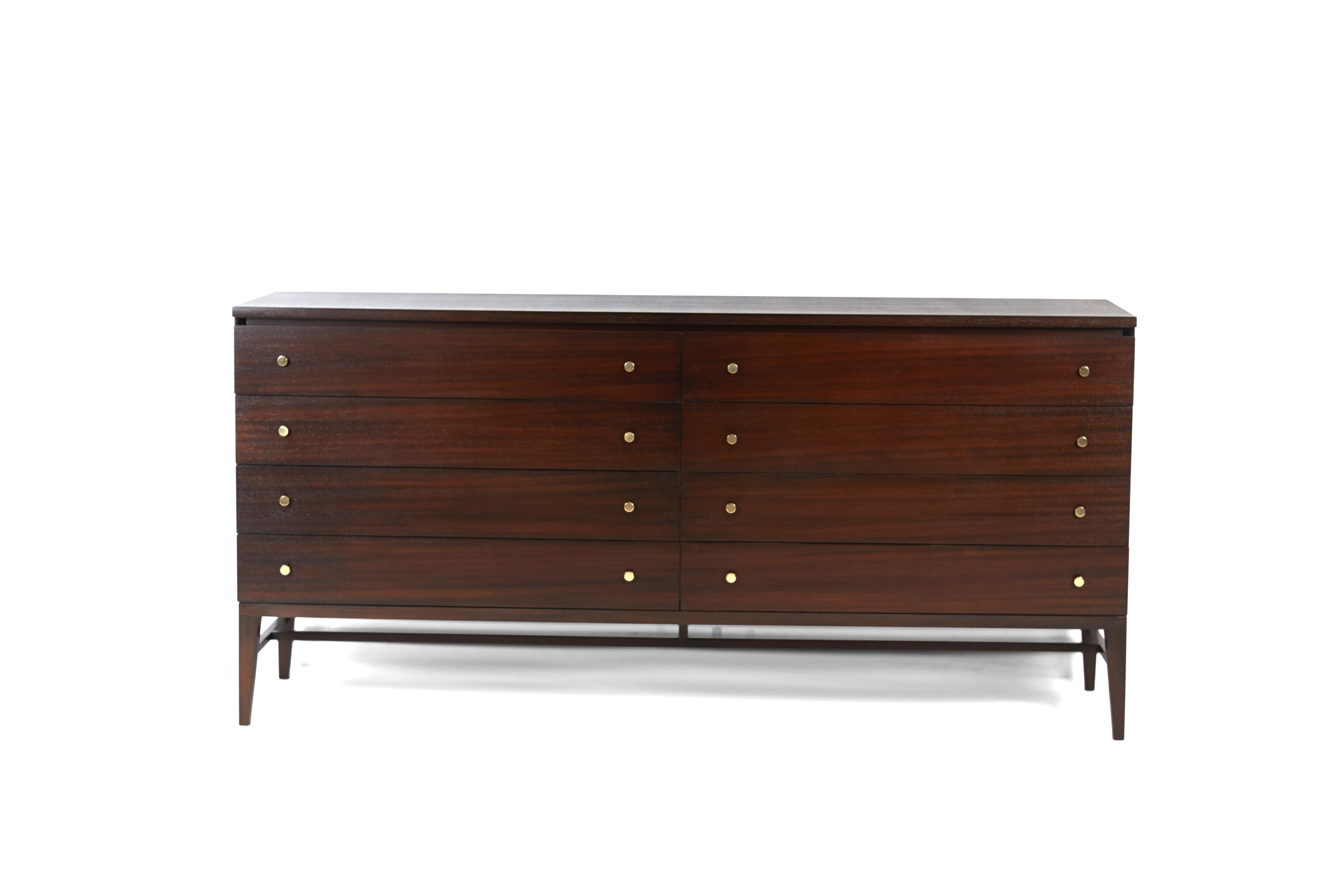 8-drawer dresser by Paul McCobb for Calvin Furniture. Cabinet has been fully restored or refinished. Retains original label and brass pulls.
 