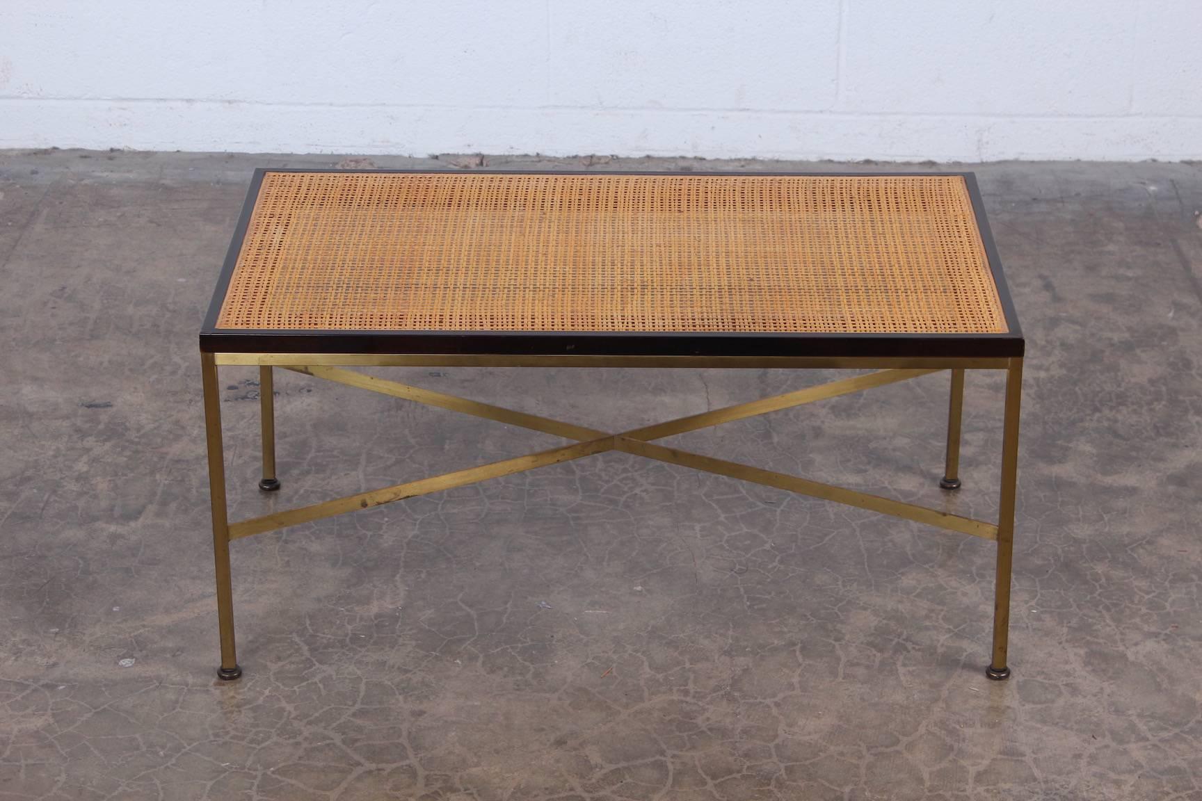 A cane and brass bench designed by Paul McCobb for Calvin. Also would be great with a glass top.