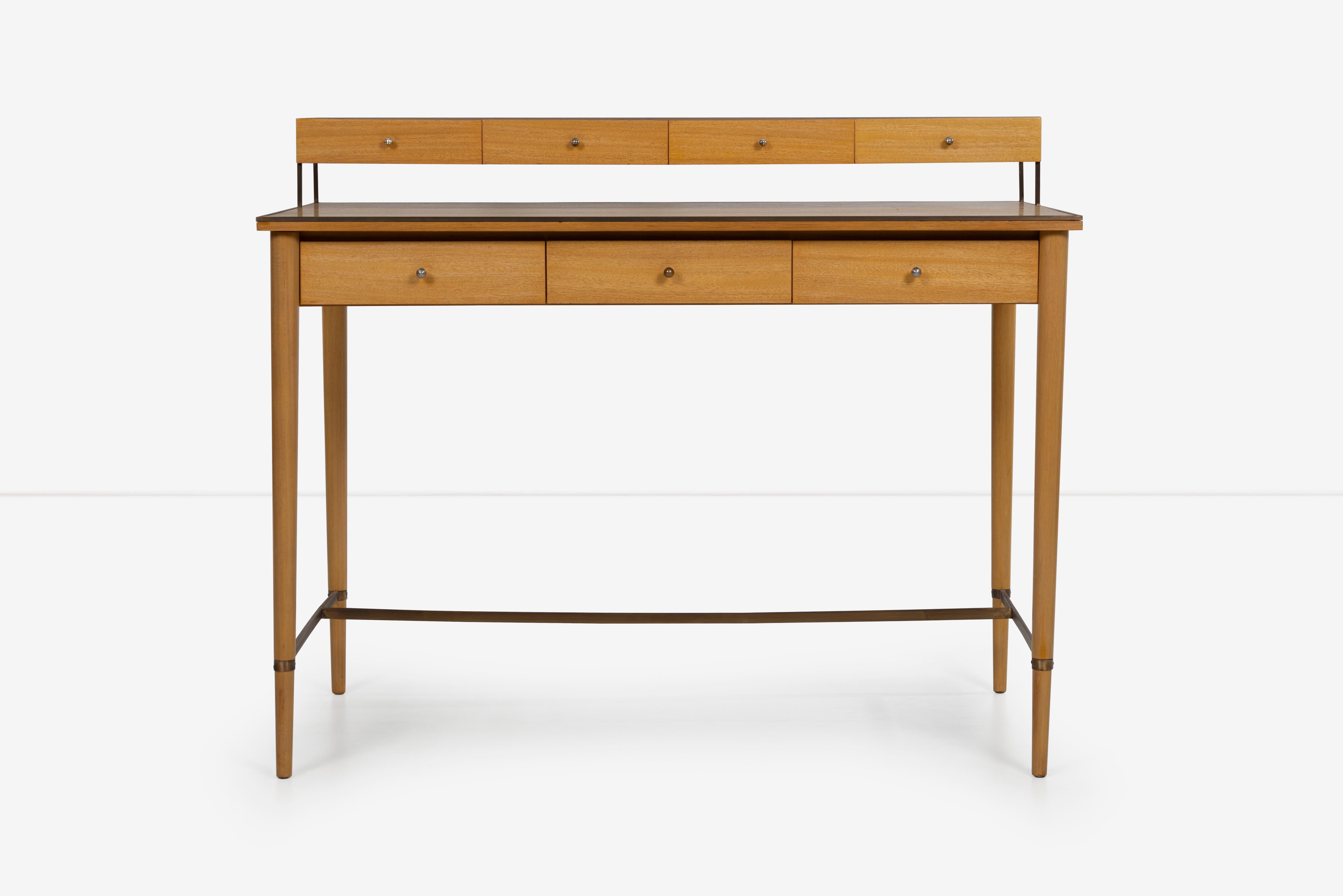 Paul McCobb brass and mahogany Connoisseur Collection writing desk, Features floating 4 drawer storage compartments and three more lower pencil drawer storage. Brass frame on edges and underside support.
[Label on inside drawer Paul McCobb