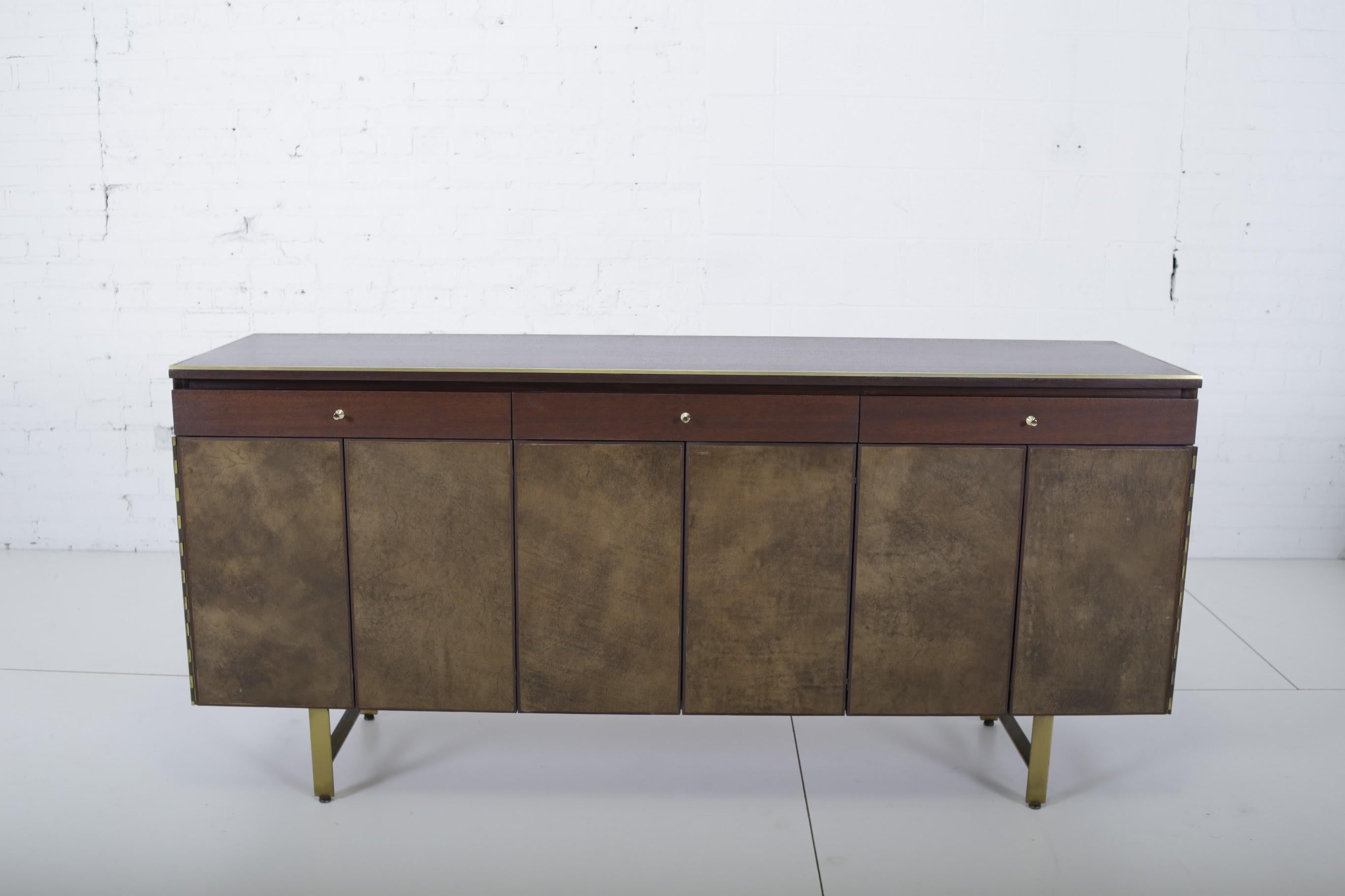 Paul McCobb for Calvin Furniture, Irwin Group sideboard with leather doors and brass base. Cabinet has been fully restored/refinished.
           