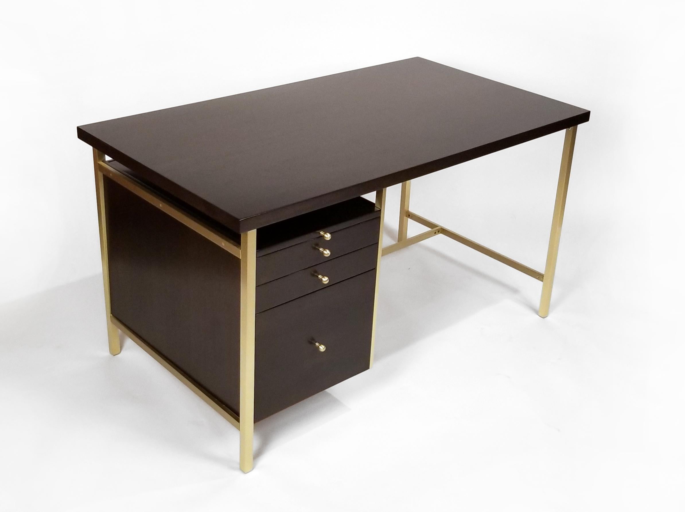 This exquisitely crafted desk was designed by Paul McCobb with a Minimalist aesthetic for his Connoisseur collection. This upscale series was produced by H. Sacks and Sons in the 1960's. Exceptional condition. The top pull engages a slide-out