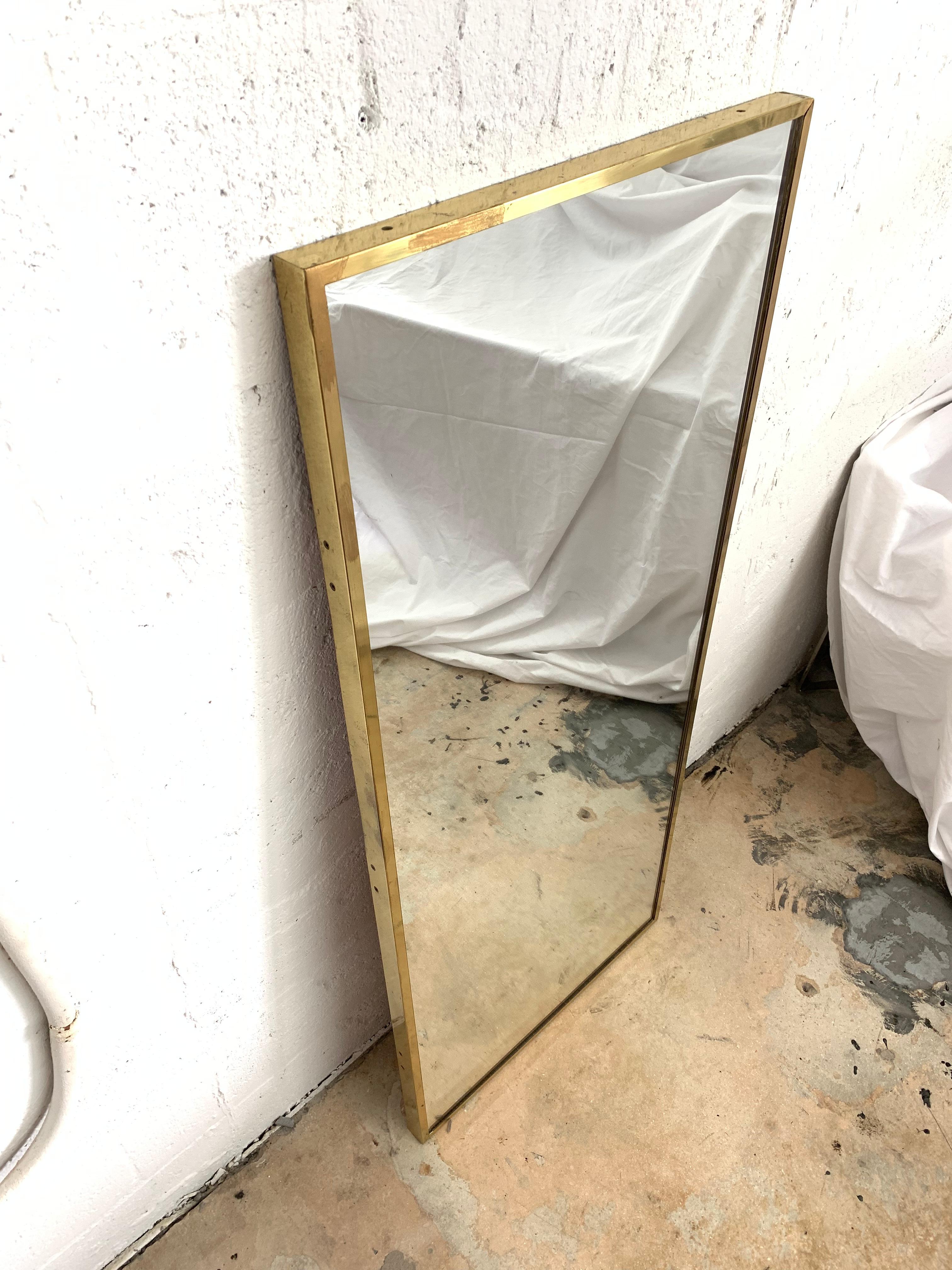 Full length wall or floor mirror rendered in Brass with inset screw details, designed by Paul McCobb for his Irwin Collection for Calvin Furniture, Signed