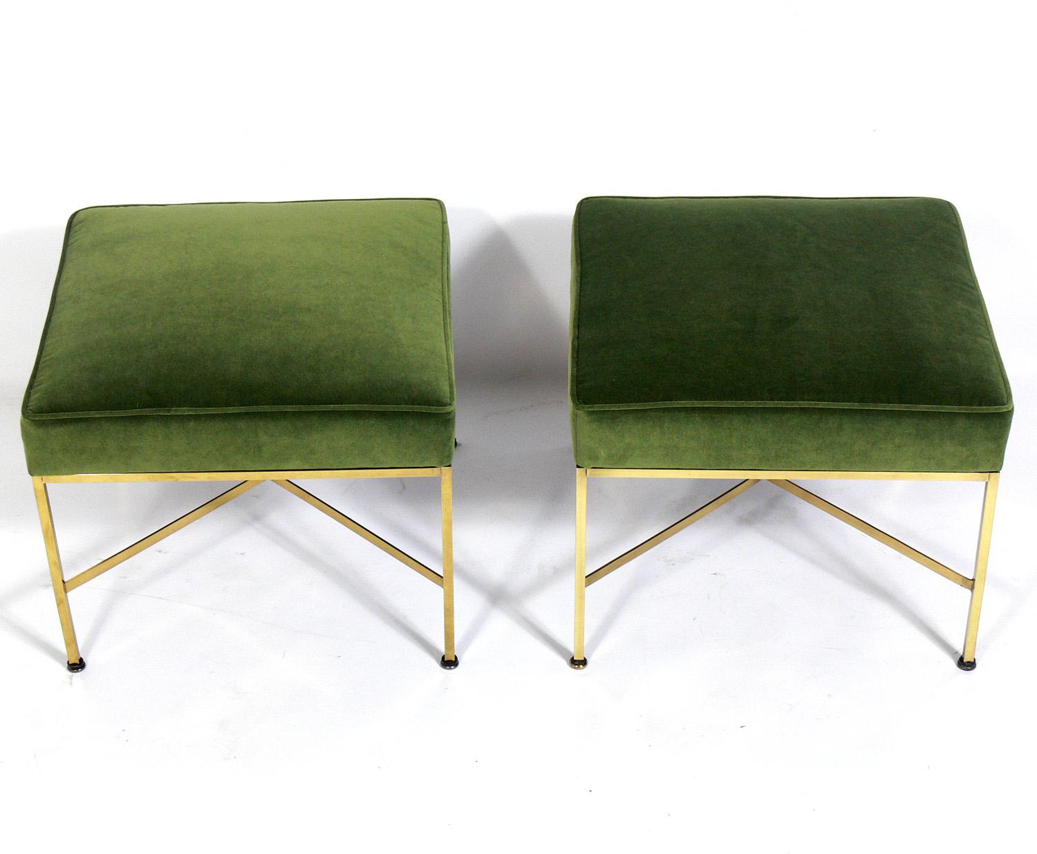 Pair of modern brass X-stools, designed by Paul McCobb, American, circa 1950s. They have been polished and lacquered and reupholstered in a fern green color velvet.