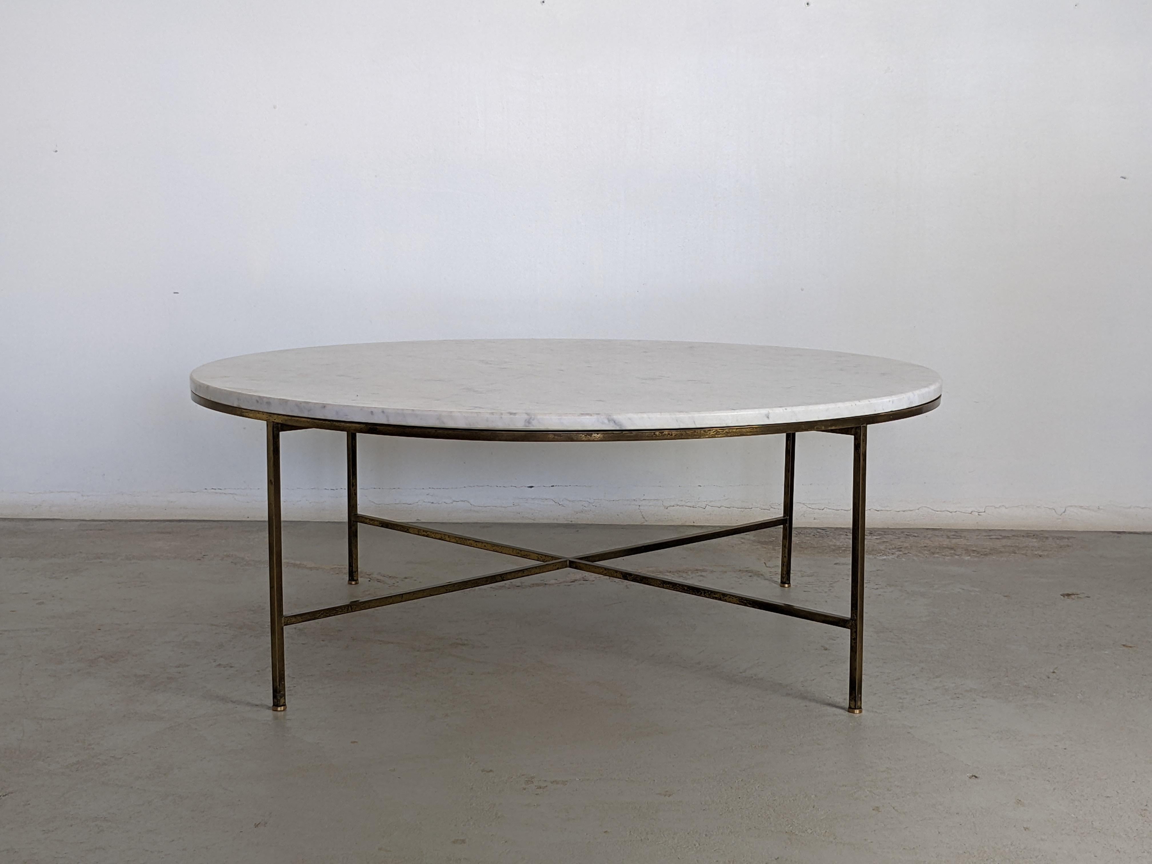 Coffee table designed by Paul McCobb for Calvin Furniture.
USA circa 1955.
Round marble top and solid brass base.
Original patina to the brass.