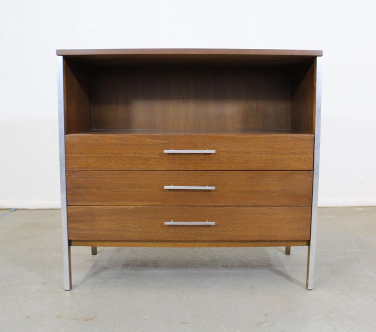Offered is a vintage Mid-Century Modern bachelor chest by Paul McCobb for Calvin Group. It is made of walnut with aluminum inserts. It is in excellent condition for its age. Has been refinished, has some slight edge wear and a few scratches, but