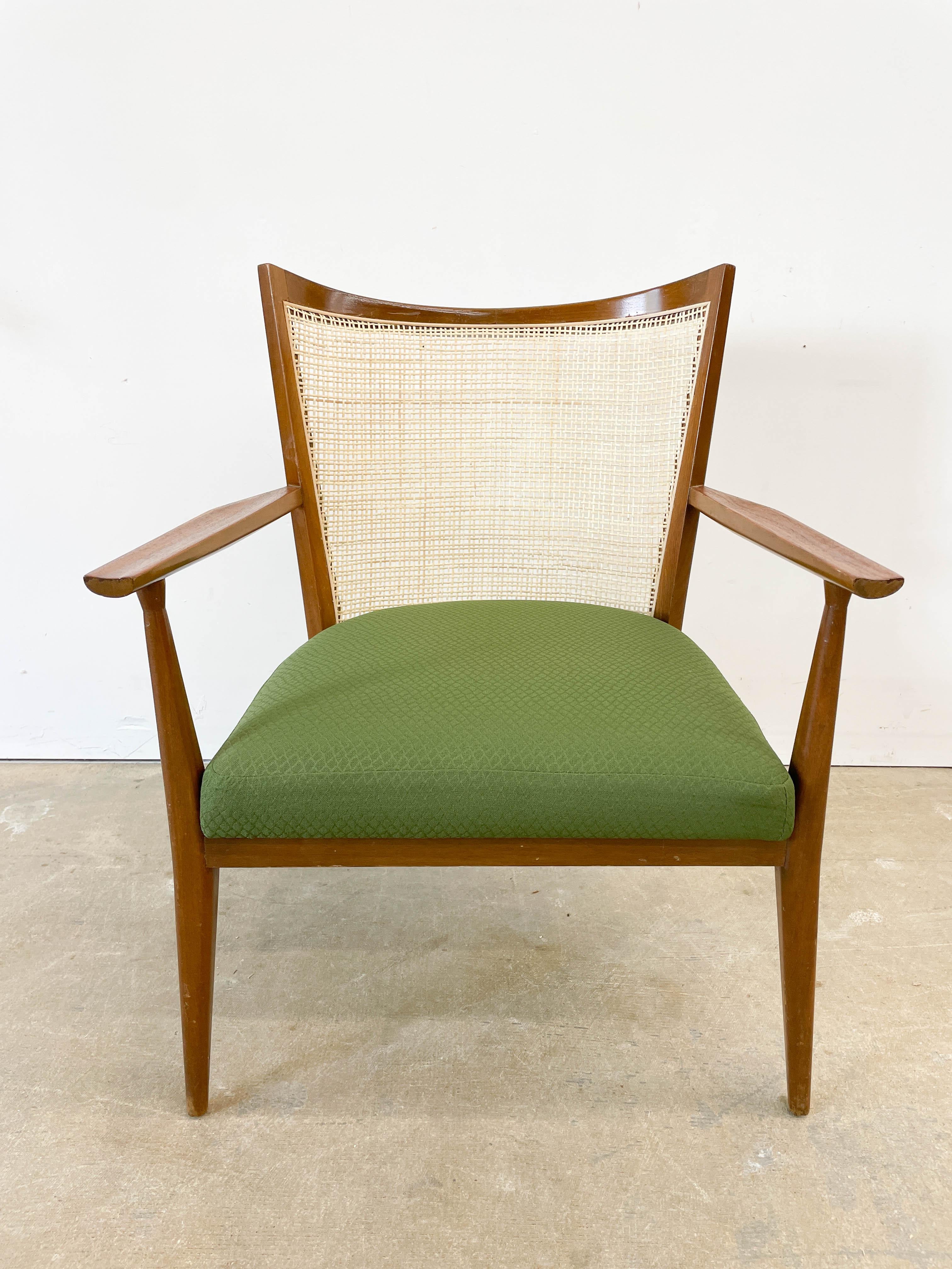 A rare walnut framed armchair with cane back designed by Paul McCobb and made by Directional Furniture in the late 1950s. A very interesting chair with both Danish and Shaker characteristics - with its combination of walnut and cane, swooping seat
