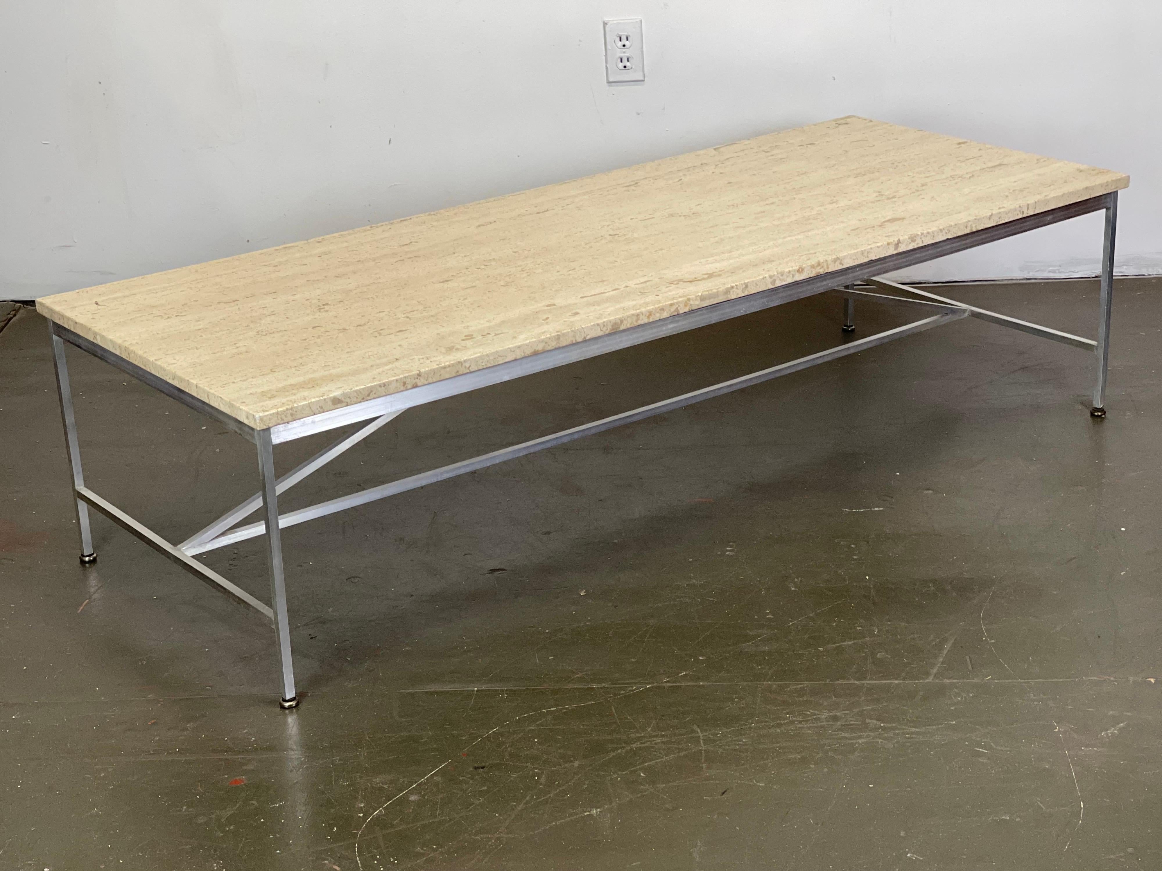 Sleek iconic Paul McCobb aluminum and travertine marble coffee table for Directional Furniture; Calvin Line. Aluminum was a special order option rather than the usual brass. Original condition - light scuffs and wear. Original feet glides. Model
