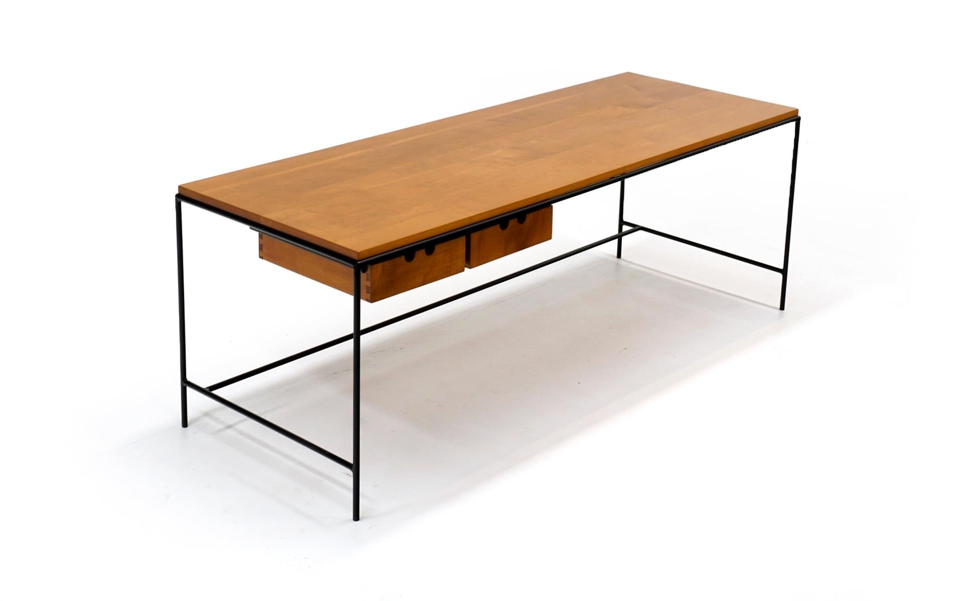 Early Planner Group coffee table designed by Paul McCobb for Winchendon Furniture Company, 1950s. Solid wrought iron frame with solid maple wood top and two drawers. Fairly large and tall rectangle at 60 inches wide, 16 inches deep and 22 inches