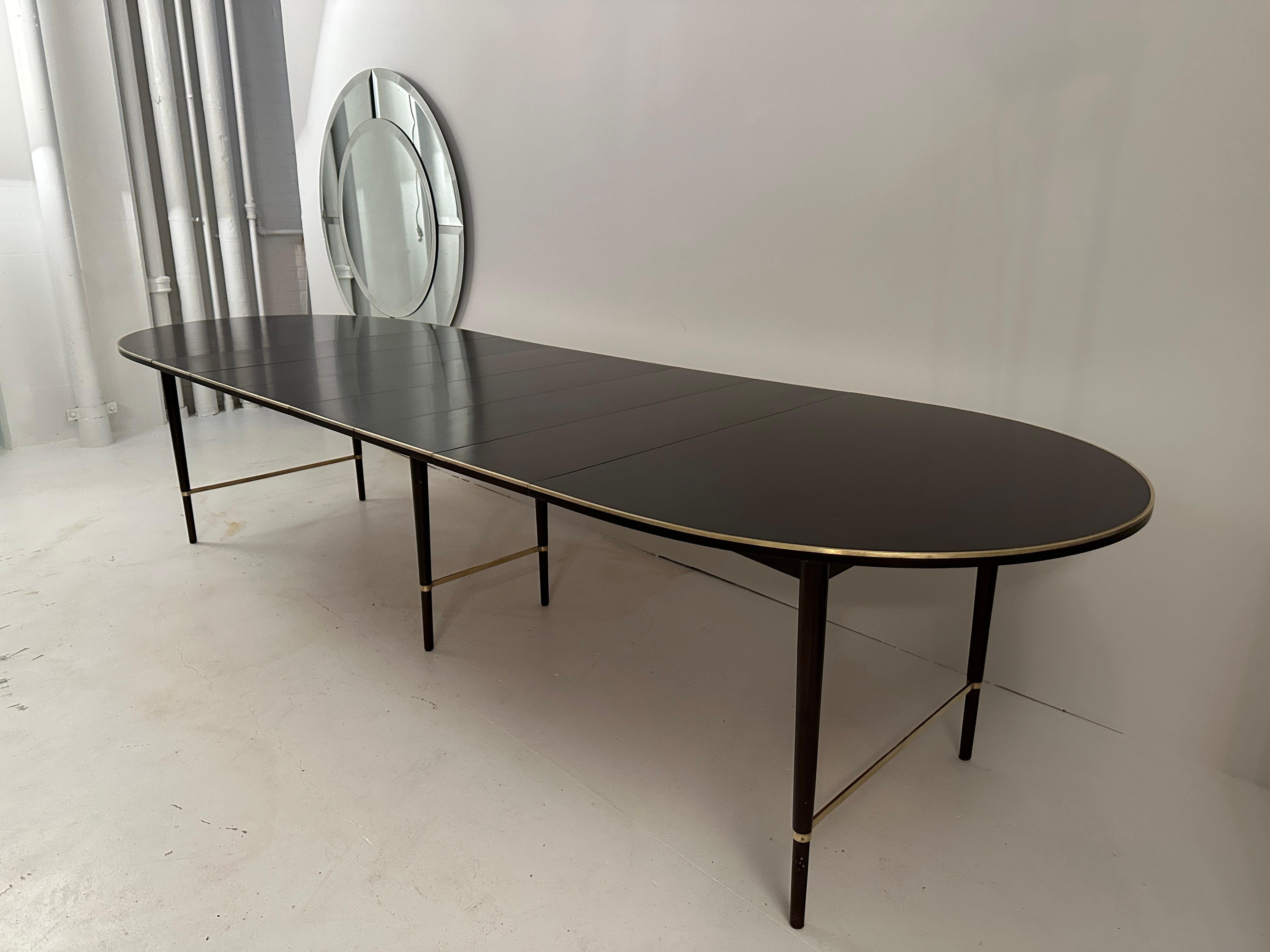 Our favorite of Paul McCobb's many iconic dining table designs, this race track oval table is wonderfully flexible. Able to be expanded from 41