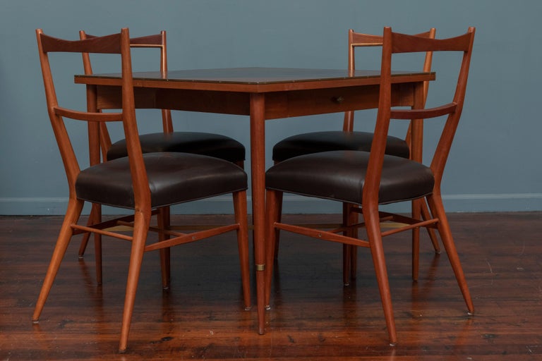 Paul McCobb Connoisseur collection games table and four matching side chairs. Classic Mid-Century Modern games table with inlaid mahogany diamond top with brass trim and stretcher with one drawer for games. Complimentory Paul McCobb design dining