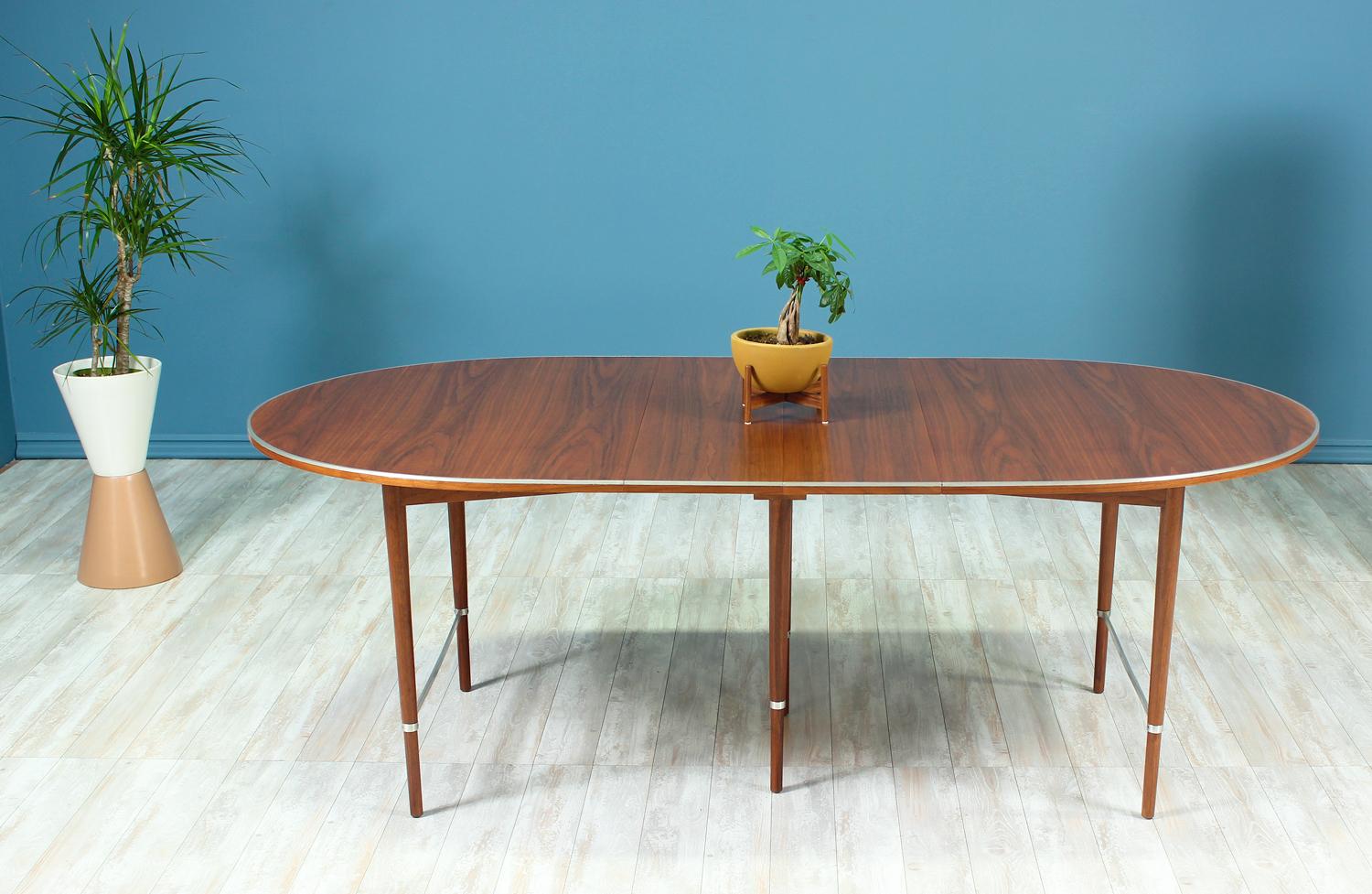 Beautiful dining table designed by Paul McCobb for H. Sacks & Sons “Connoisseur” line in the United States circa 1950’s. A Mid-Century modern sleek design that shows the quality craftsmanship of designer Paul McCobb. This dining table features an