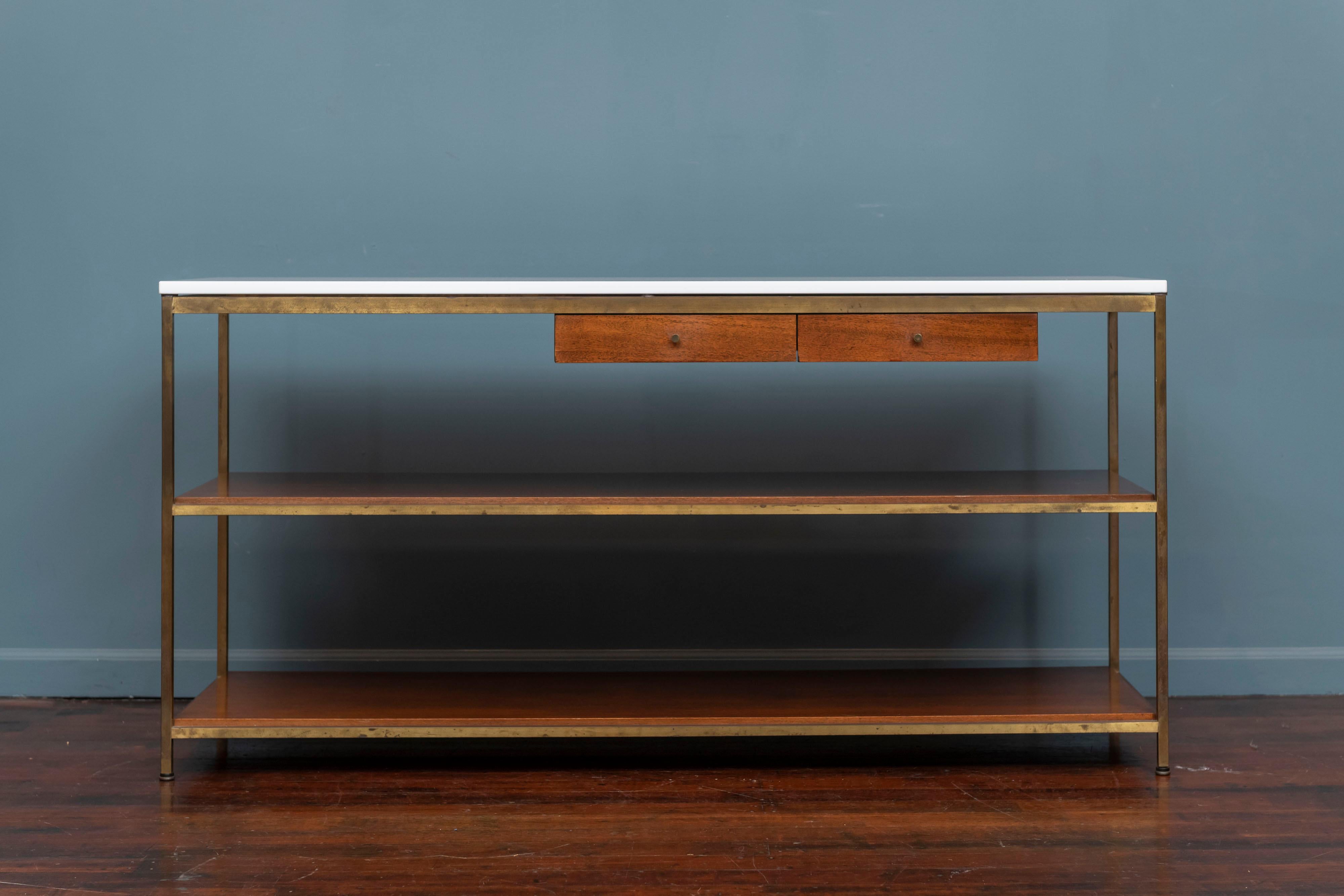 Mid-Century Modern console table or server designed by Paul McCobb for Calvin Furniture, part of his Irwin collection. Console has two drawers and two lower shelves in mahogany and supported by a brass frame with original white vitrolite glass top.