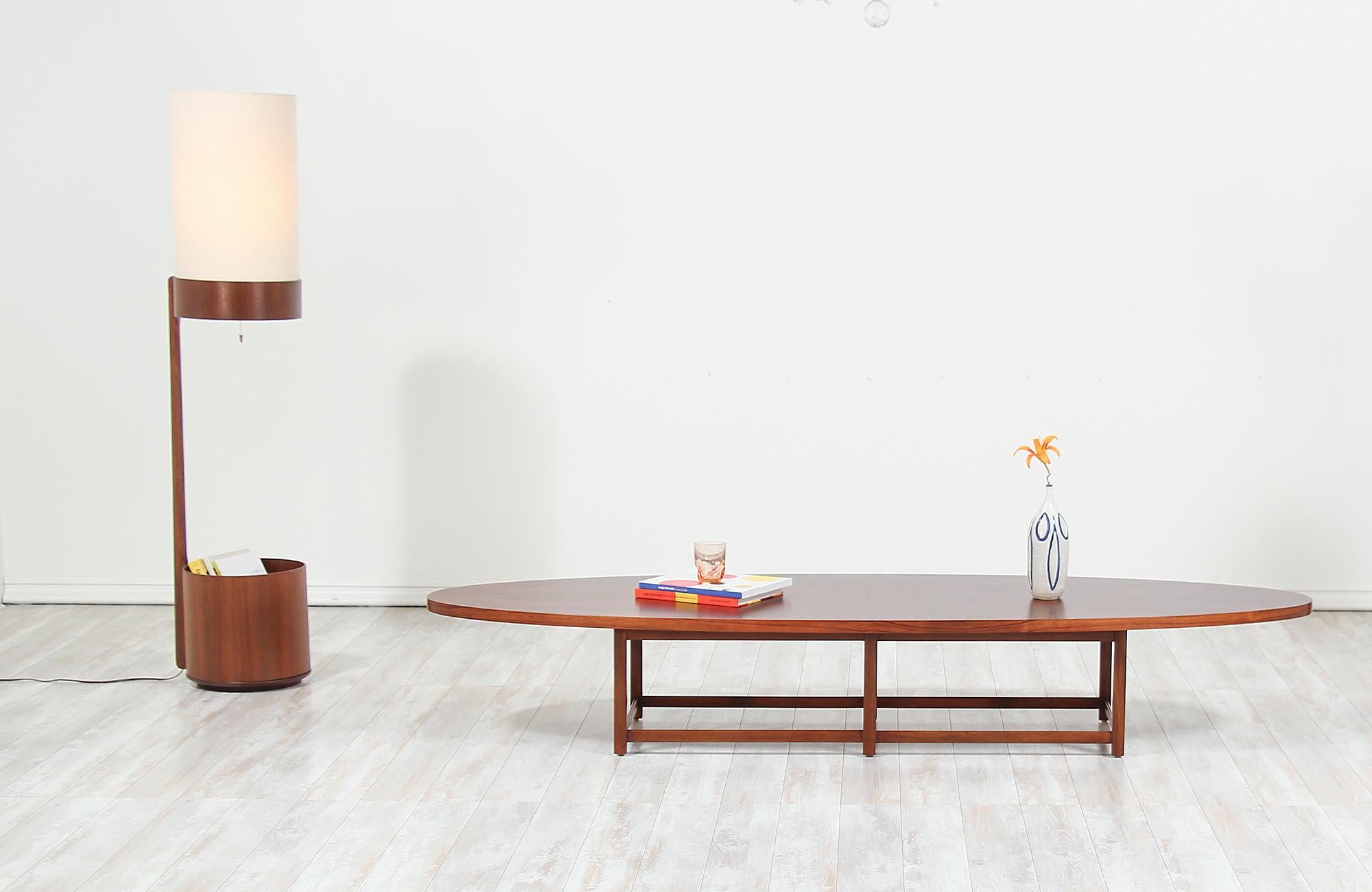 Beautiful modern coffee table designed by Paul McCobb for Lane’s “Delineator” collection in the United States, circa 1950s. This coffee table features a Brazilian rosewood top with a crafted walnut base showcasing a fusion of geometric forms with