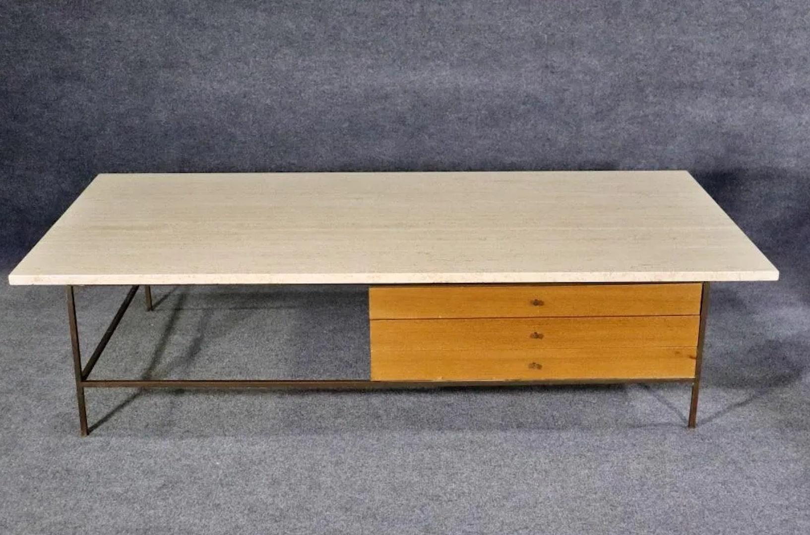 Large coffee table designed by Paul McCobb for his Irwin Collection. Heavy travertine top set on a brass frame with drawers.
Please confirm location.