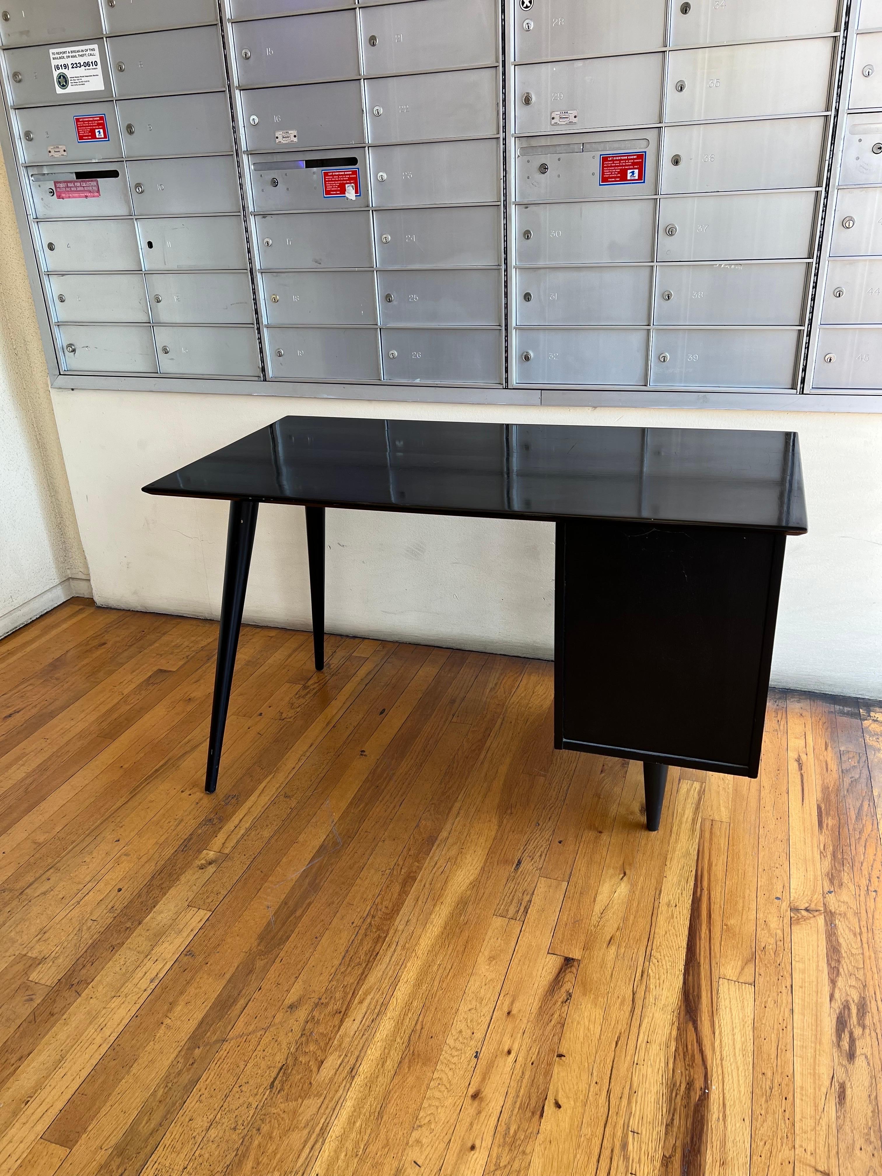 A good-looking Paul McCobb desk and chair, in original black lacquer finish we have cleaned and polished the desk but shows marks due to age we like the look of it nicely worn its Sold as/is condition.