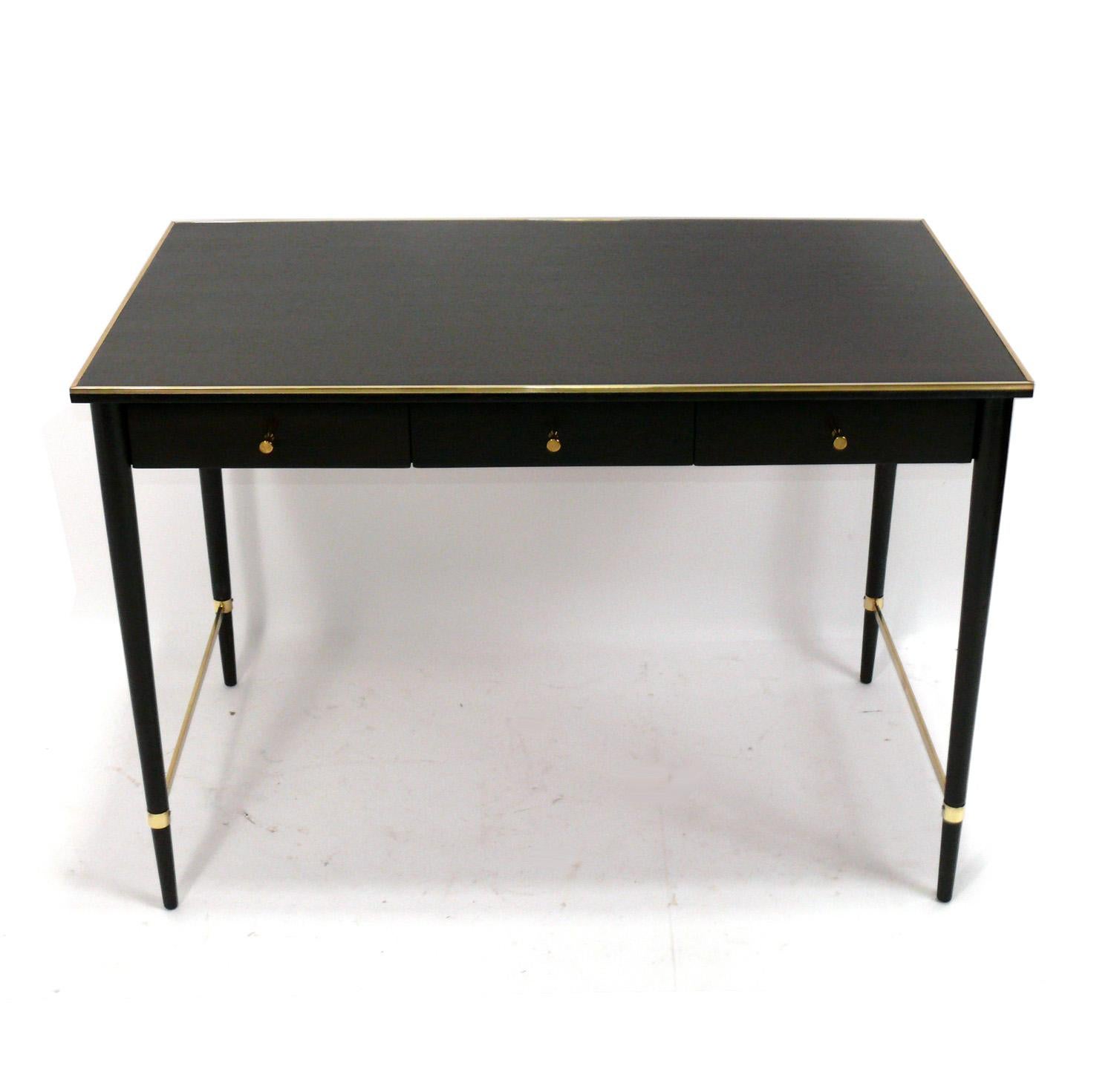 Elegant Mid Century Desk, designed by Paul McCobb for The Connoisseur Collection by H. Sacks, American, circa 1950s. It has recently been refinished and the brass elements have been hand polished and lacquered. It is a versatile size and can be used