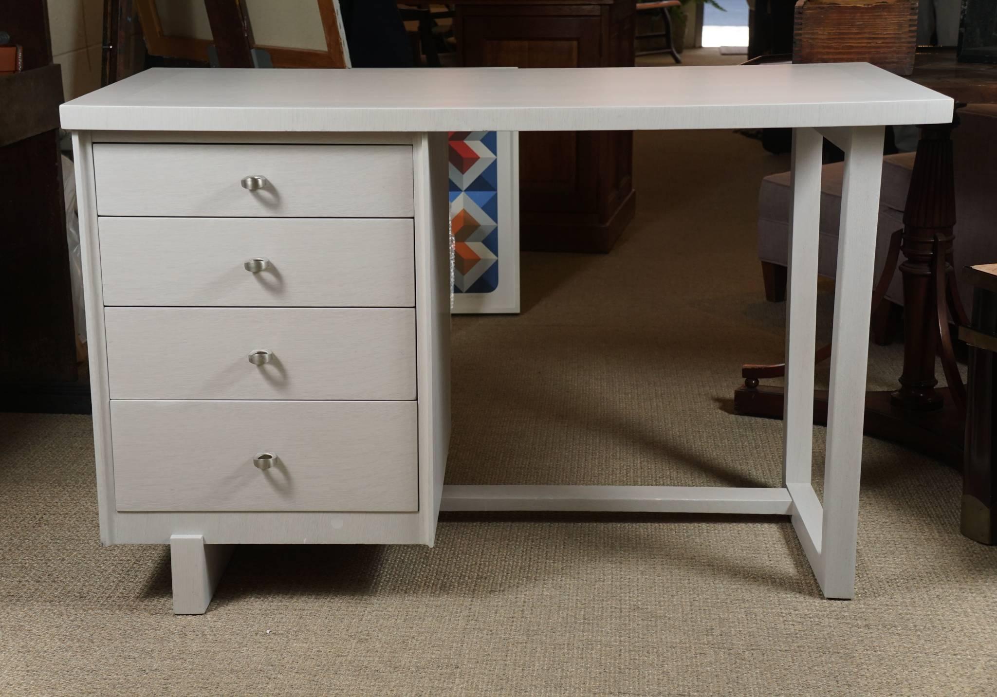Here is a great Paul McCobb desk that has been refinished in a cream colored white washed finish. 
The desk has four drawers and brushed chrome pulls and is in excellent condition.