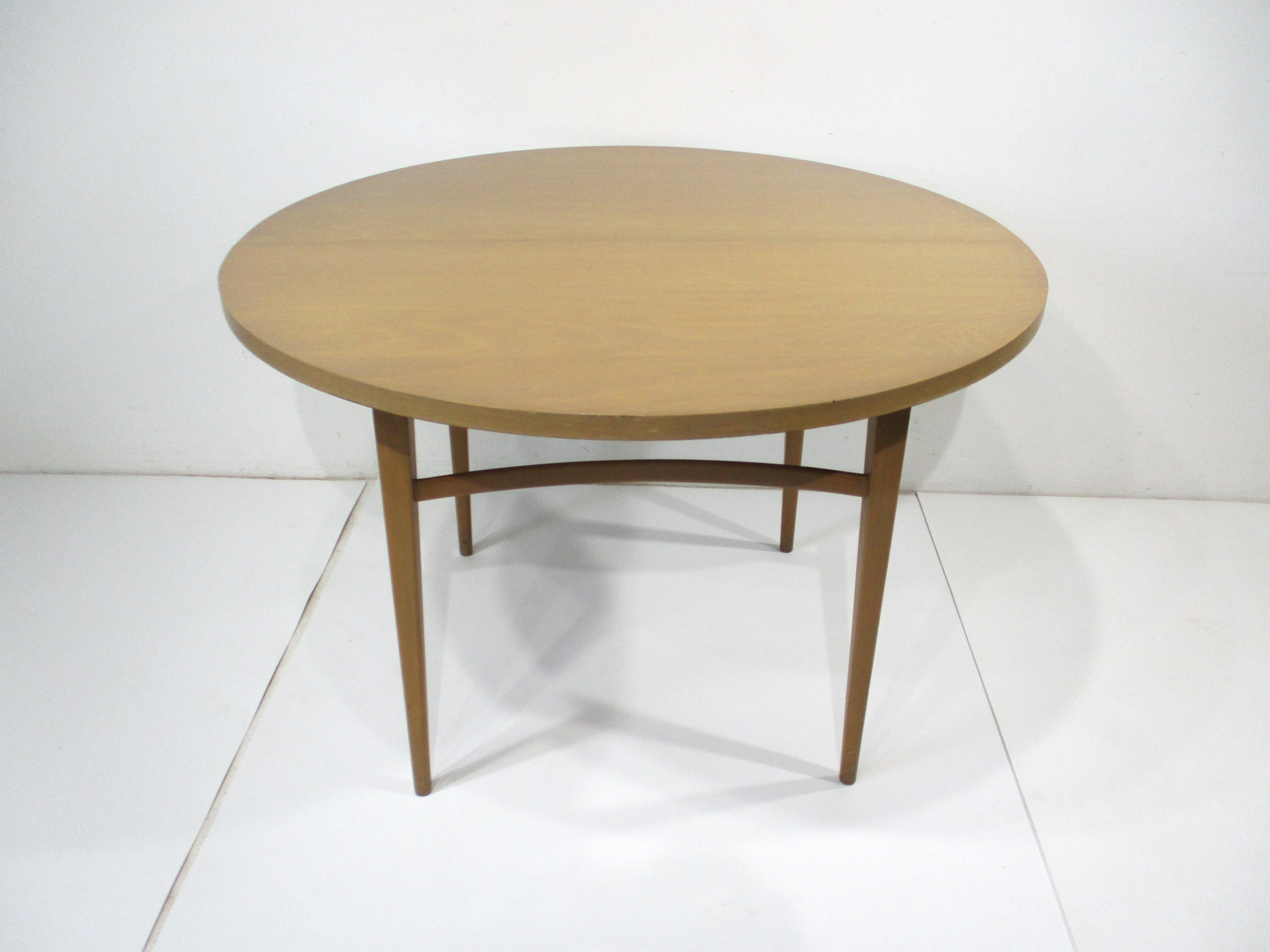 A Mid Century clear maple wood dining table with three 14