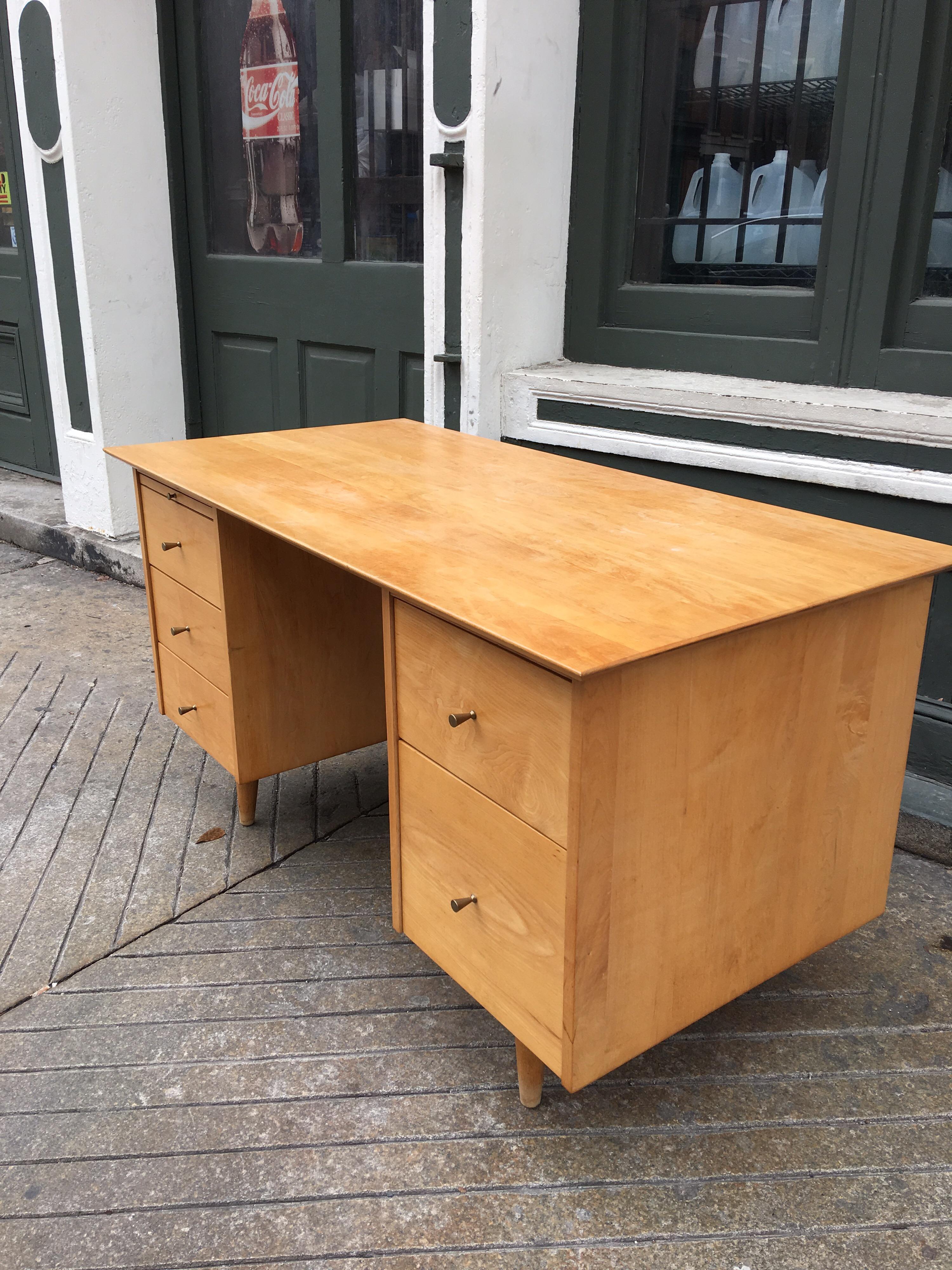 Paul McCobb double pedestal desk with pullout / pull-out work surface. Original blond finish, top shows a little wear, but overall very presentable! Desk is finished on all sides so it would look great away from a wall! Second pedestal gives plenty