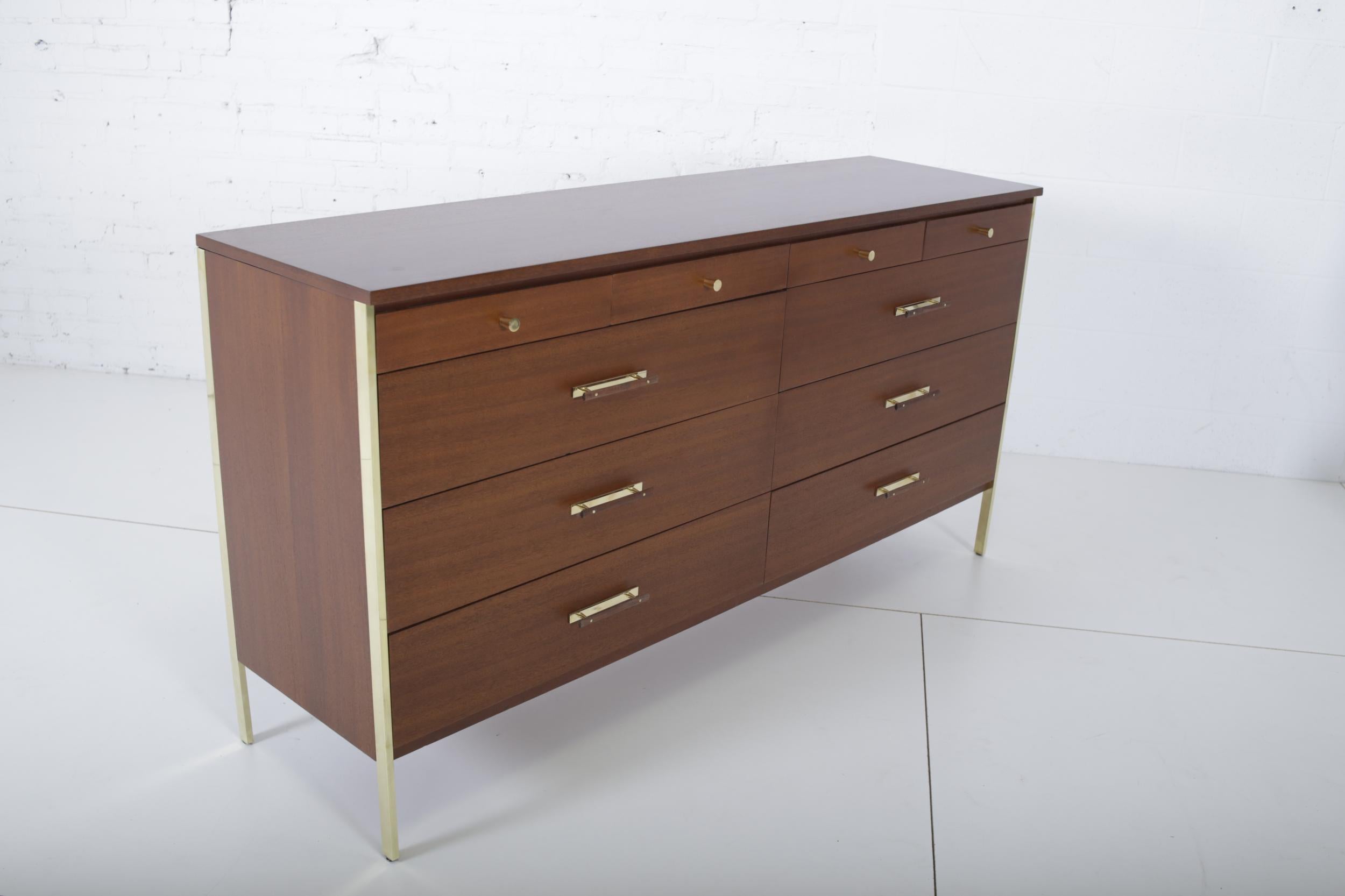 Paul McCobb dresser for Calvin Furniture, circa 1950s. Dresser has brass trim and brass hardware.
