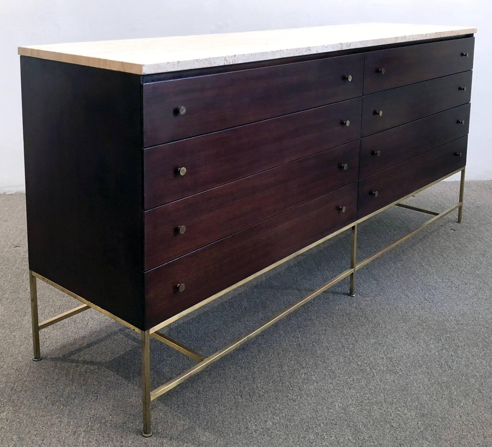 Eight-drawer dresser or sideboard from the Irwin collection designed by Paul McCobb for Calvin. Features a travertine top, brass pulls and base, with mahogany. Finished on all sides. Retains original label.