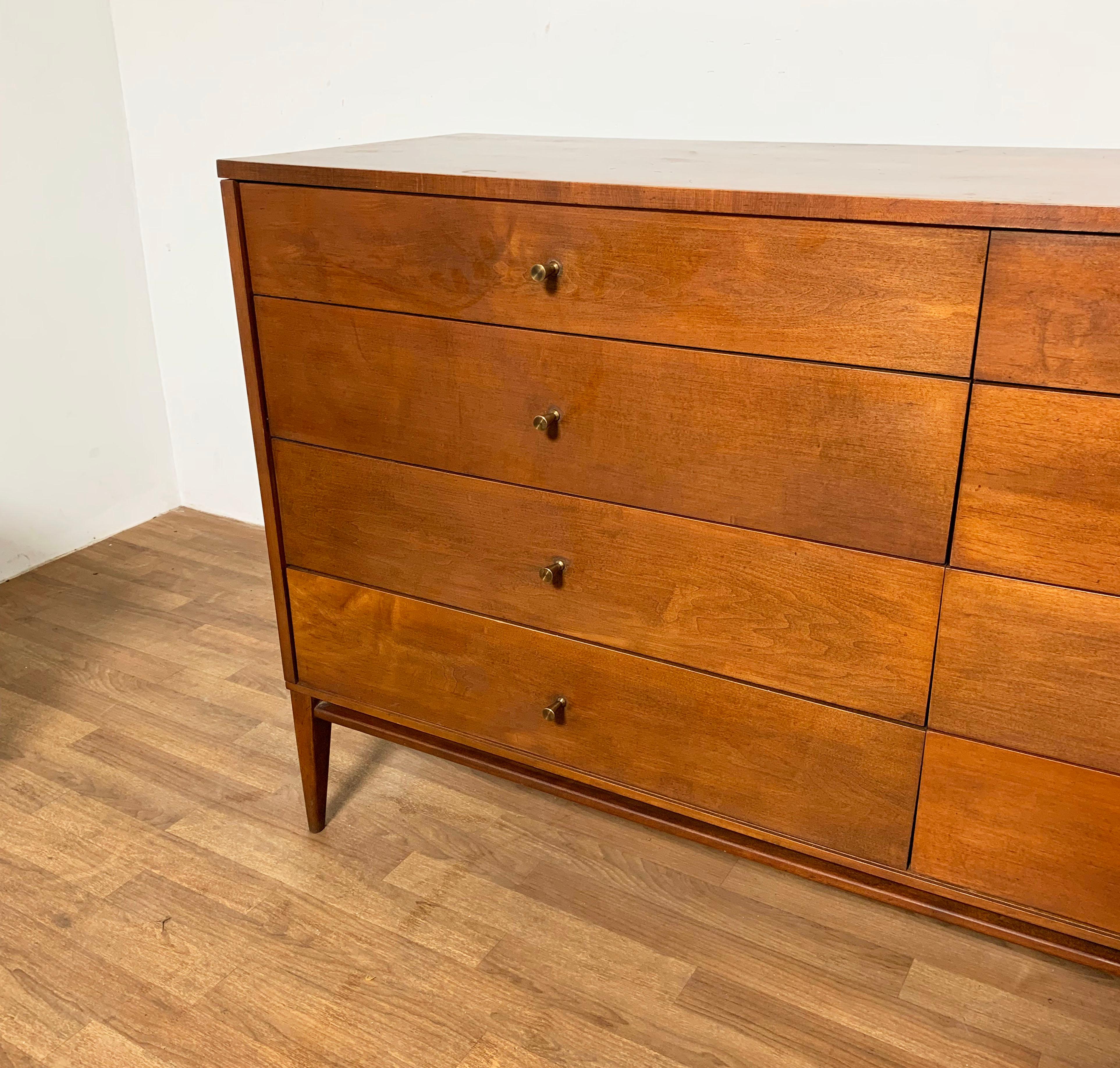 An eight drawer dresser by Paul McCobb for Winchendon Furniture in original light tobacco finish.