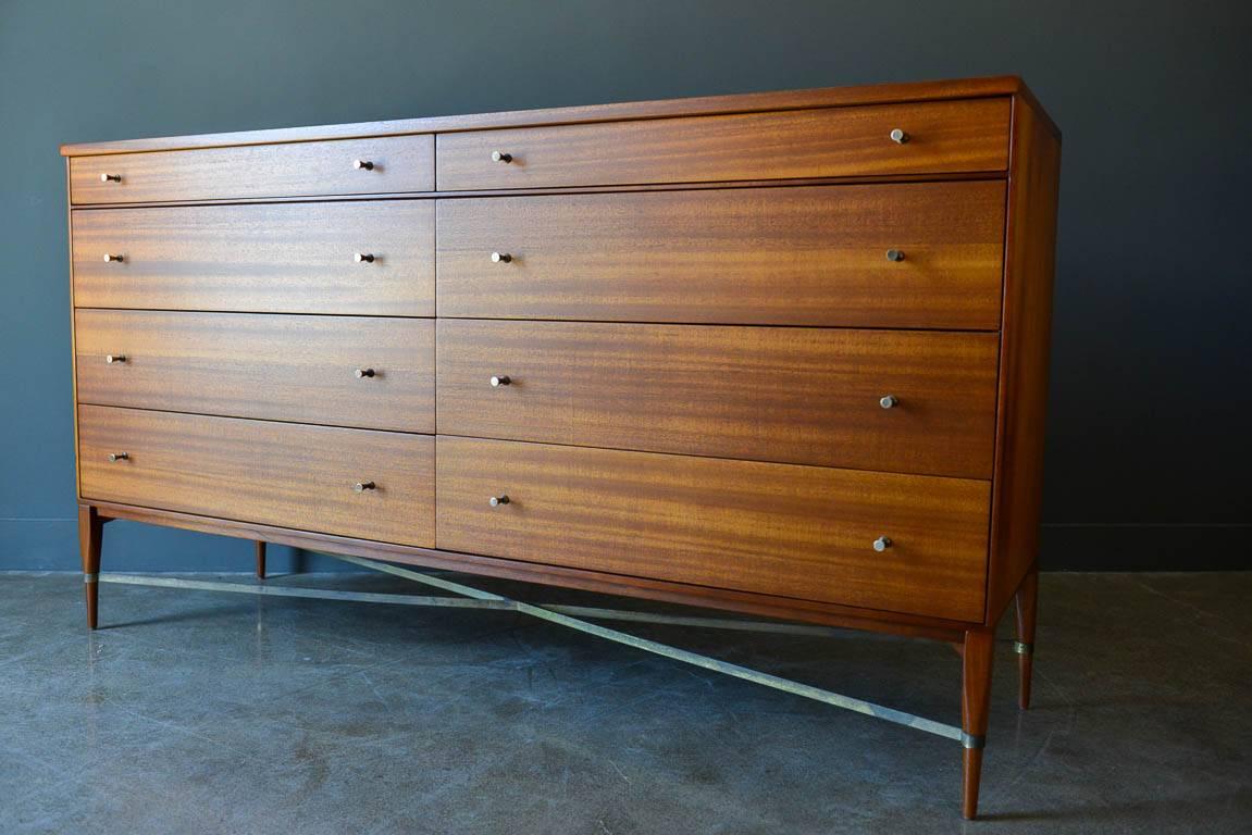 Paul McCobb eight-drawer mahogany dresser with brass X-base stretchers, circa 1960. Part of the popular and higher end 'Connoisseur Collection' with included brass detailing and exceptional craftsmanship. Professionally restored in showroom perfect