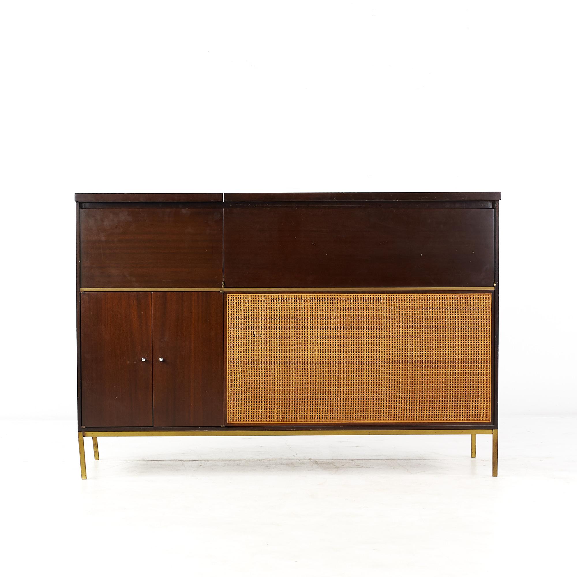 Paul McCobb for Bell and Howell Mid Century cane and brass Stereo Console

This stereo console measures: 50 wide x 19 deep x 33.75 inches high

All pieces of furniture can be had in what we call restored vintage condition. That means the piece