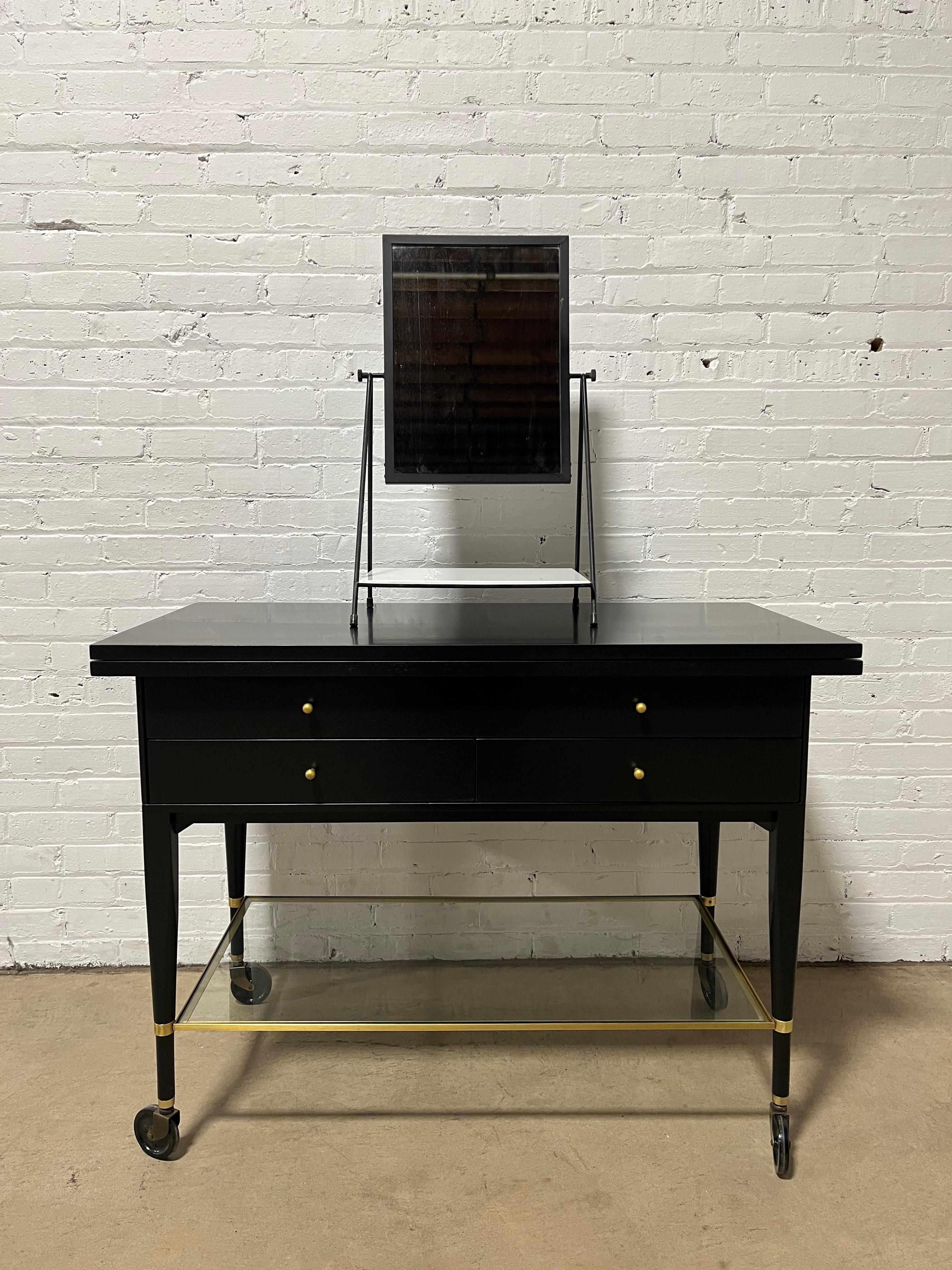 A rare and exceptional Mid-Century Modern swiveling table top vanity mirror

By Paul McCobb for Bryce Originals

USA, 1950s

Black enameled steel, with original white Vitrolite glass shelf.

Measures: 15